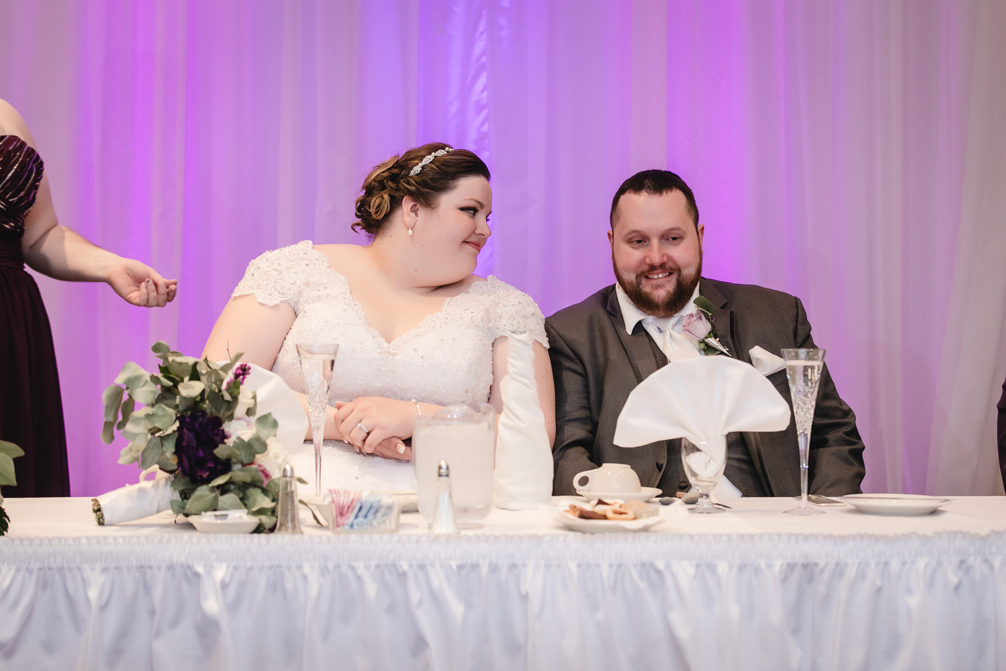 Newlyweds enjoy the speeches at their Fez wedding reception