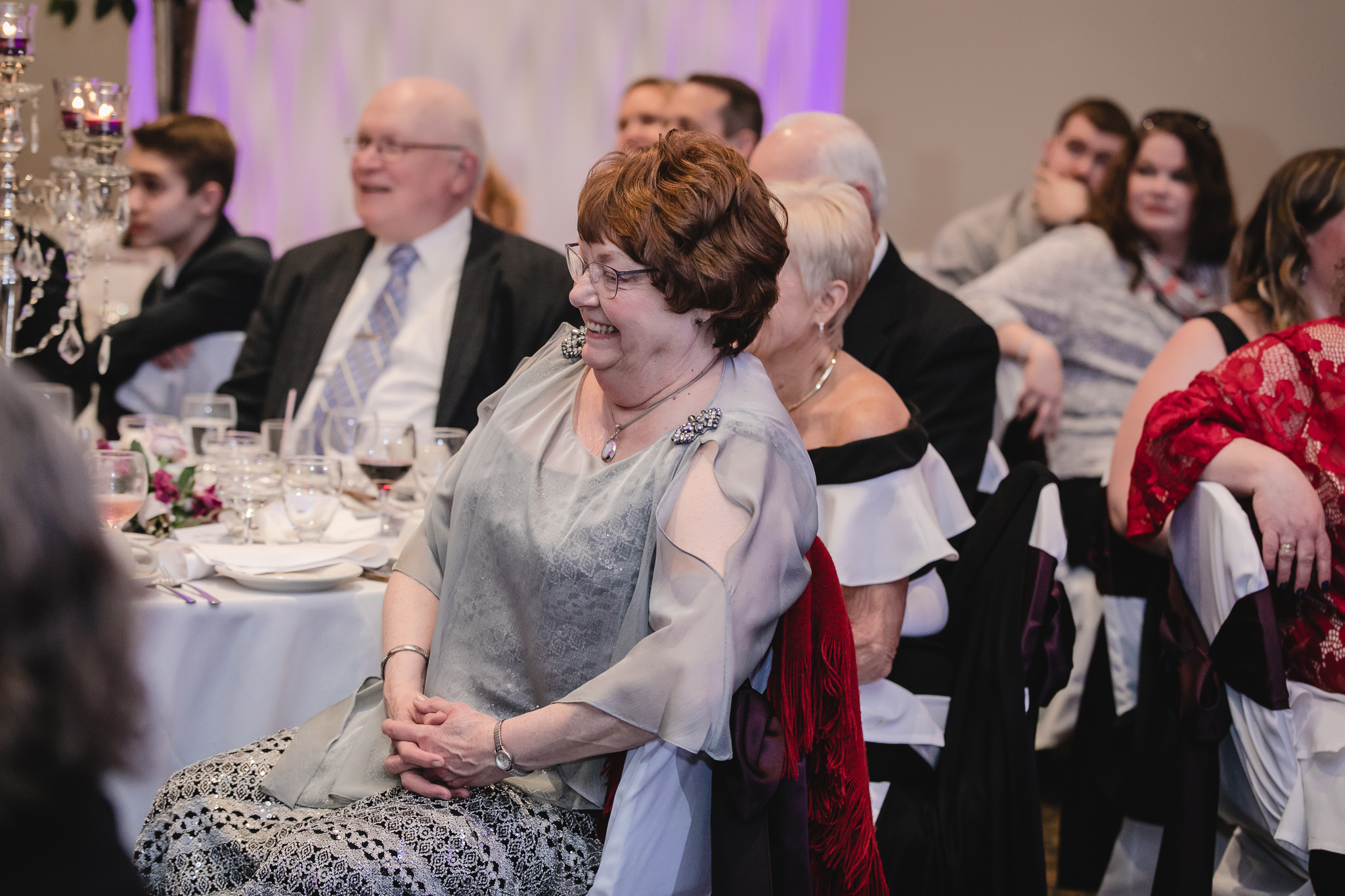Mother of the groom laughs during best man speech at the Fez