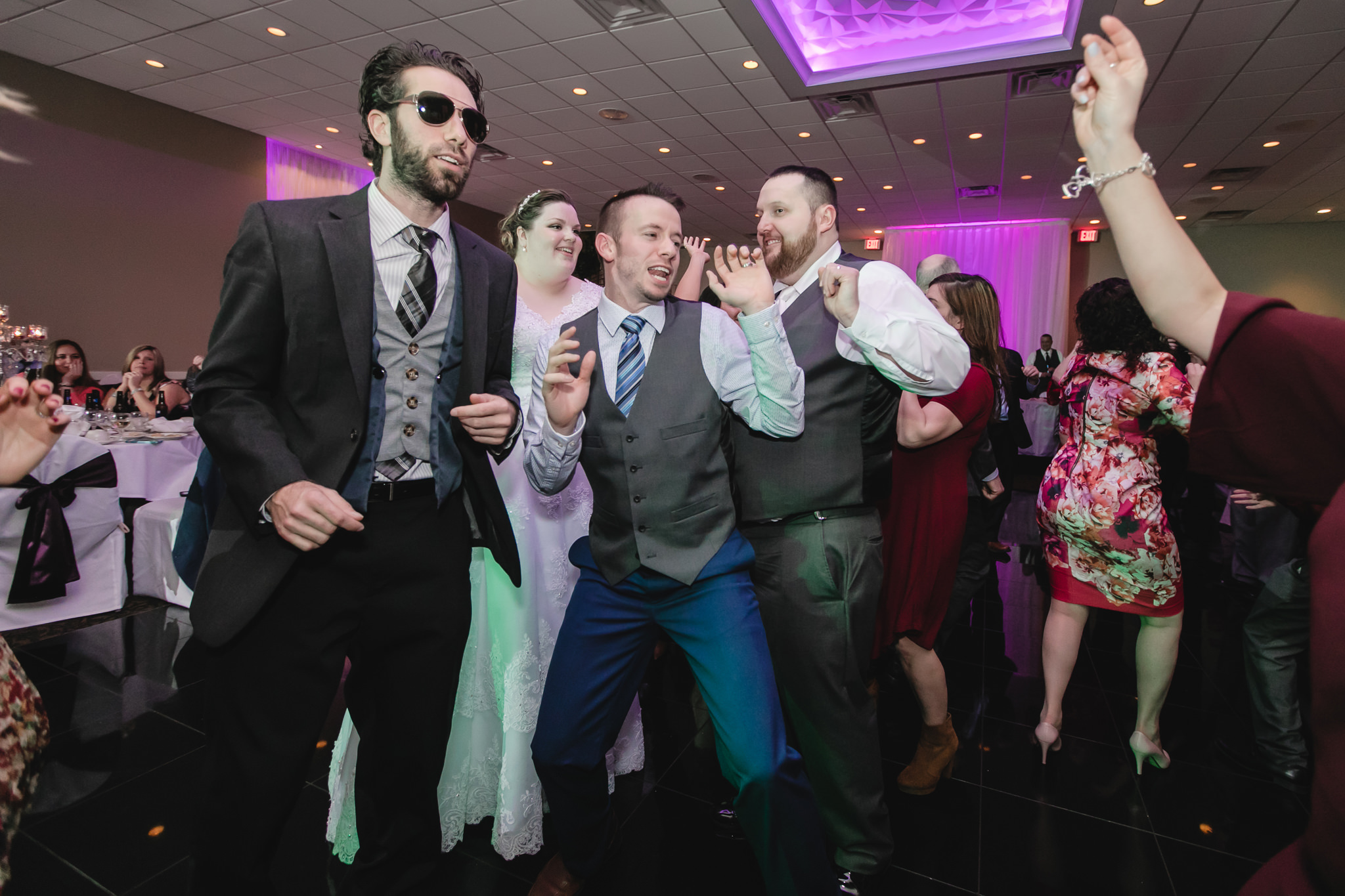 Guests dance with the newlyweds during their spring wedding at the Fez