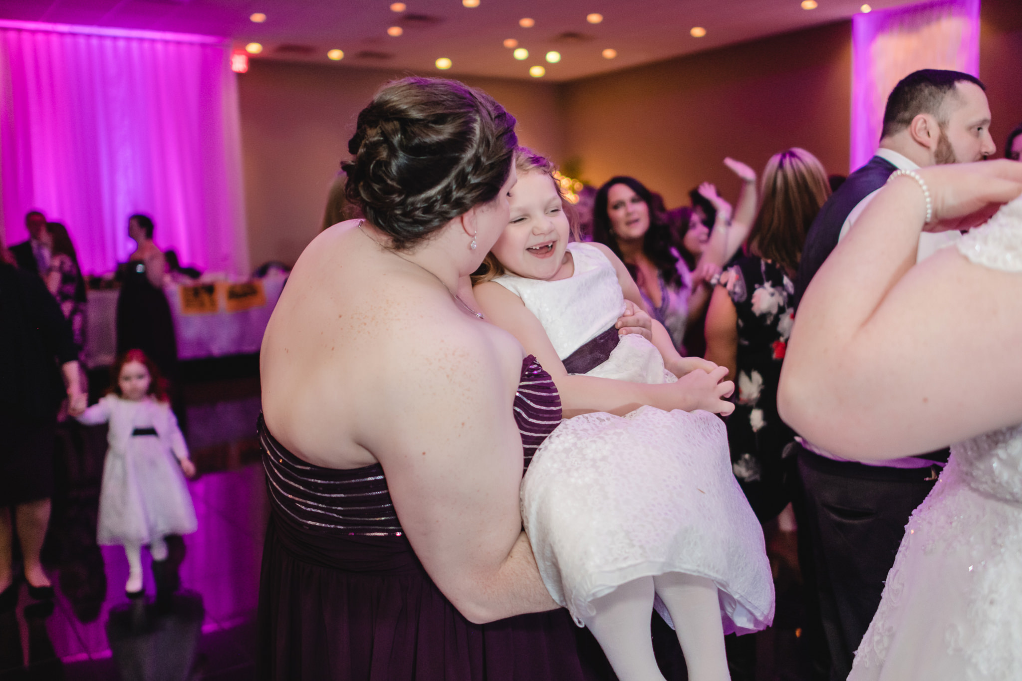 Bridesmaid dances with the flower girl at the Fez