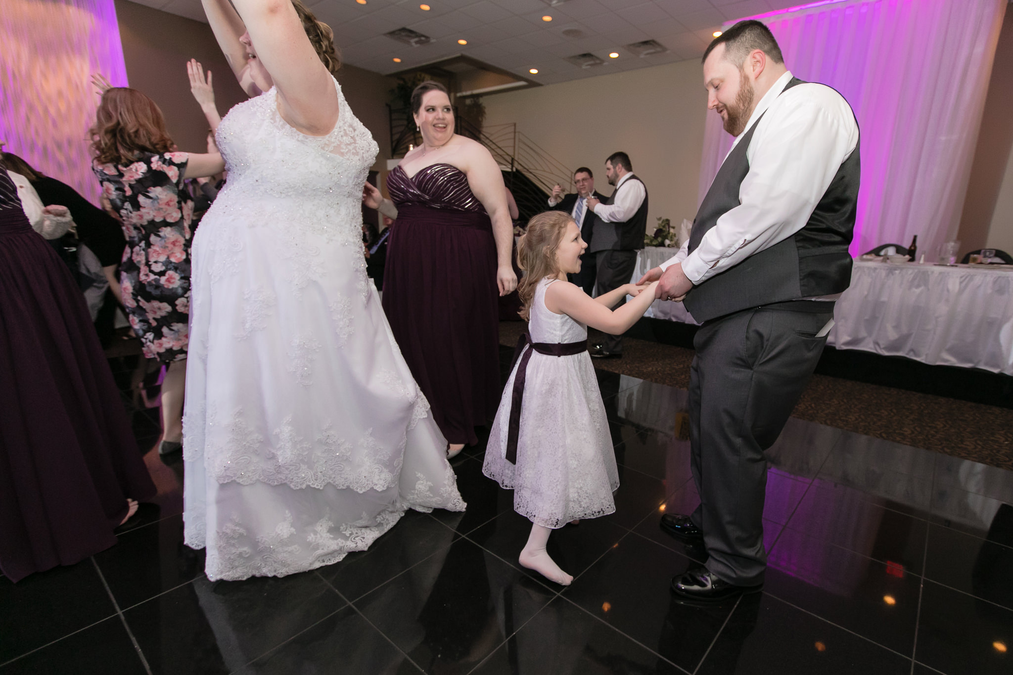 Groom dances with the flower girl at his spring wedding at the Fez