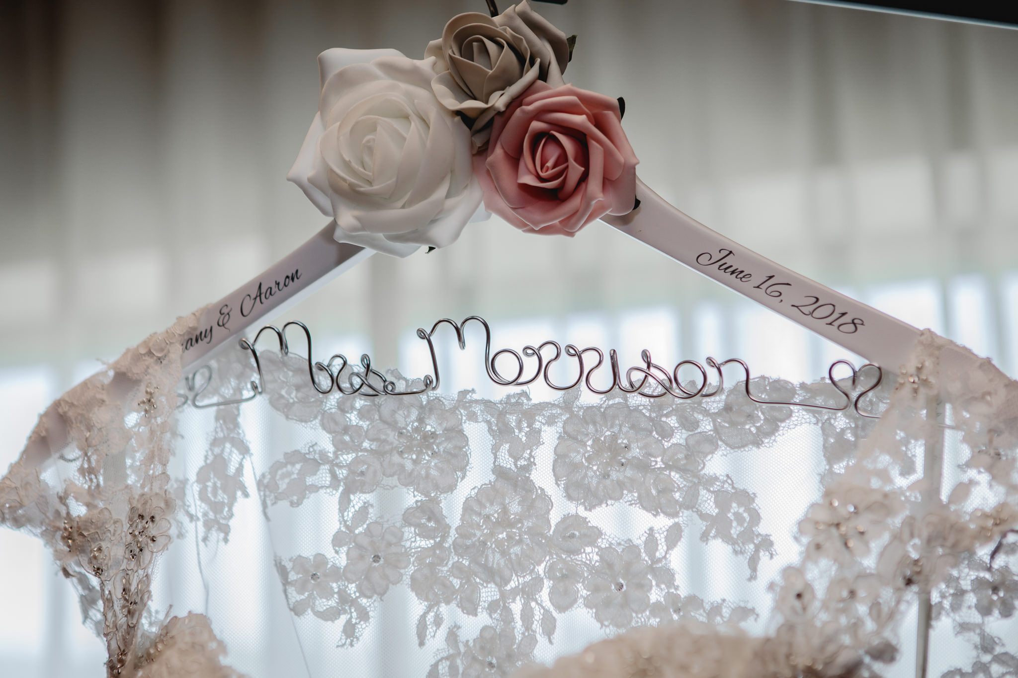 Custom hanger holds the bride's lace wedding dress at Chestnut Ridge Golf Resort