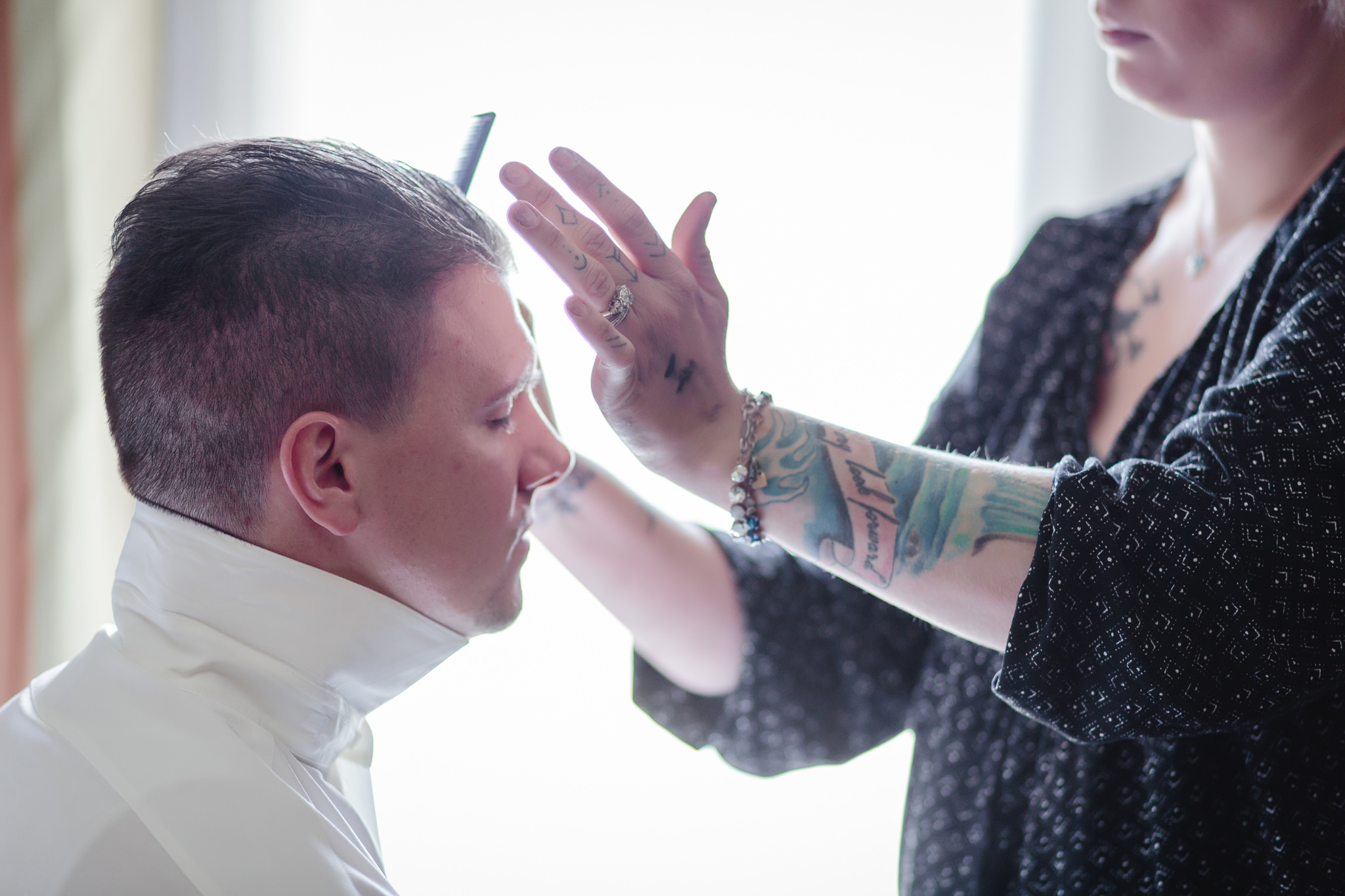 Groom gets his hair styled on his wedding day at Chestnut Ridge Golf Resort