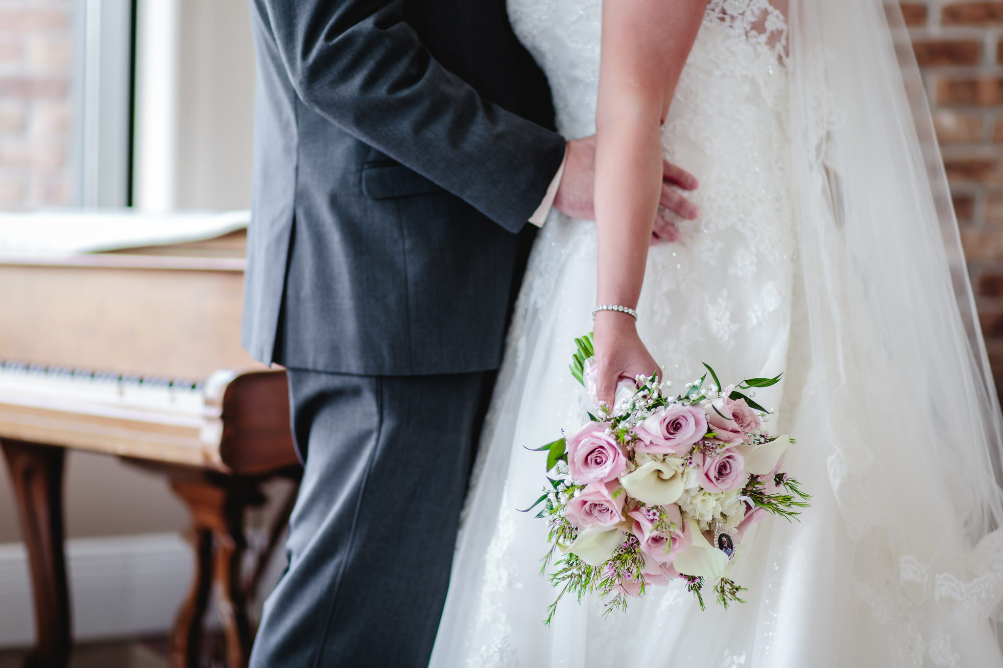 Bride's bouquet hangs by her side at Chestnut Ridge Golf Resort