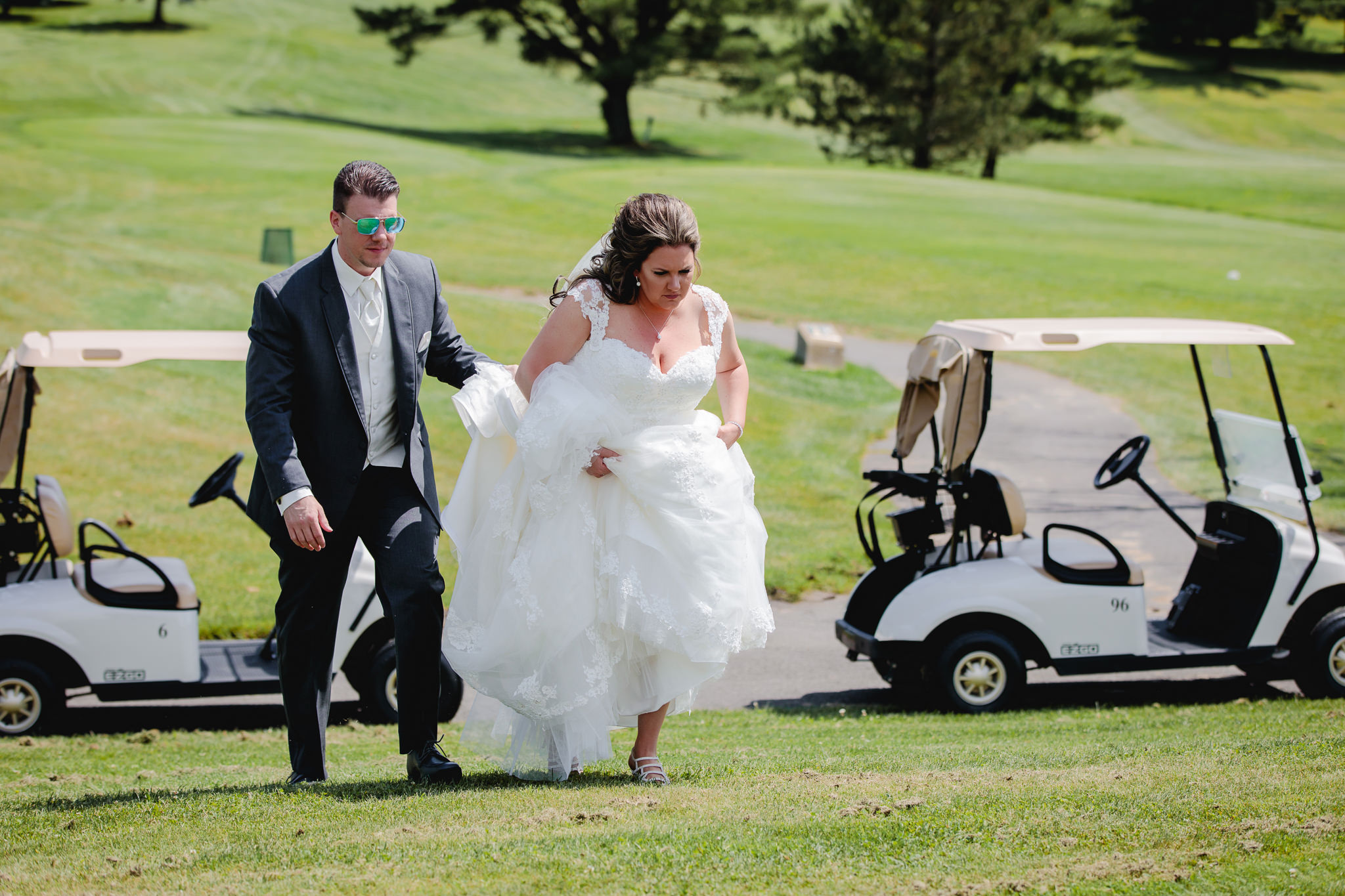 Bride and groom talk golf carts to photo locations at Chestnut Ridge Golf Resort