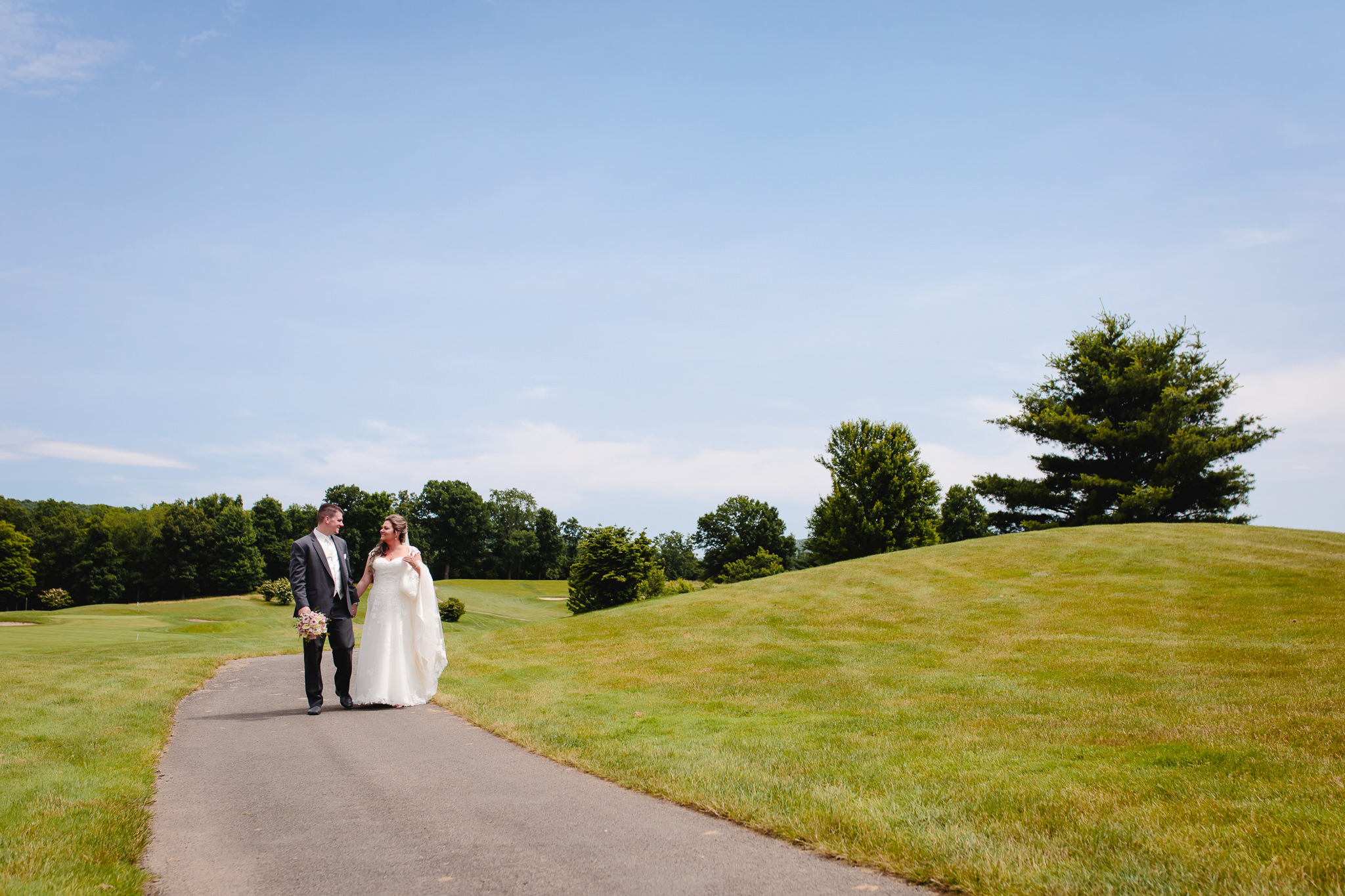 Bride & groom walk together at Chestnut Ridge Golf Resort