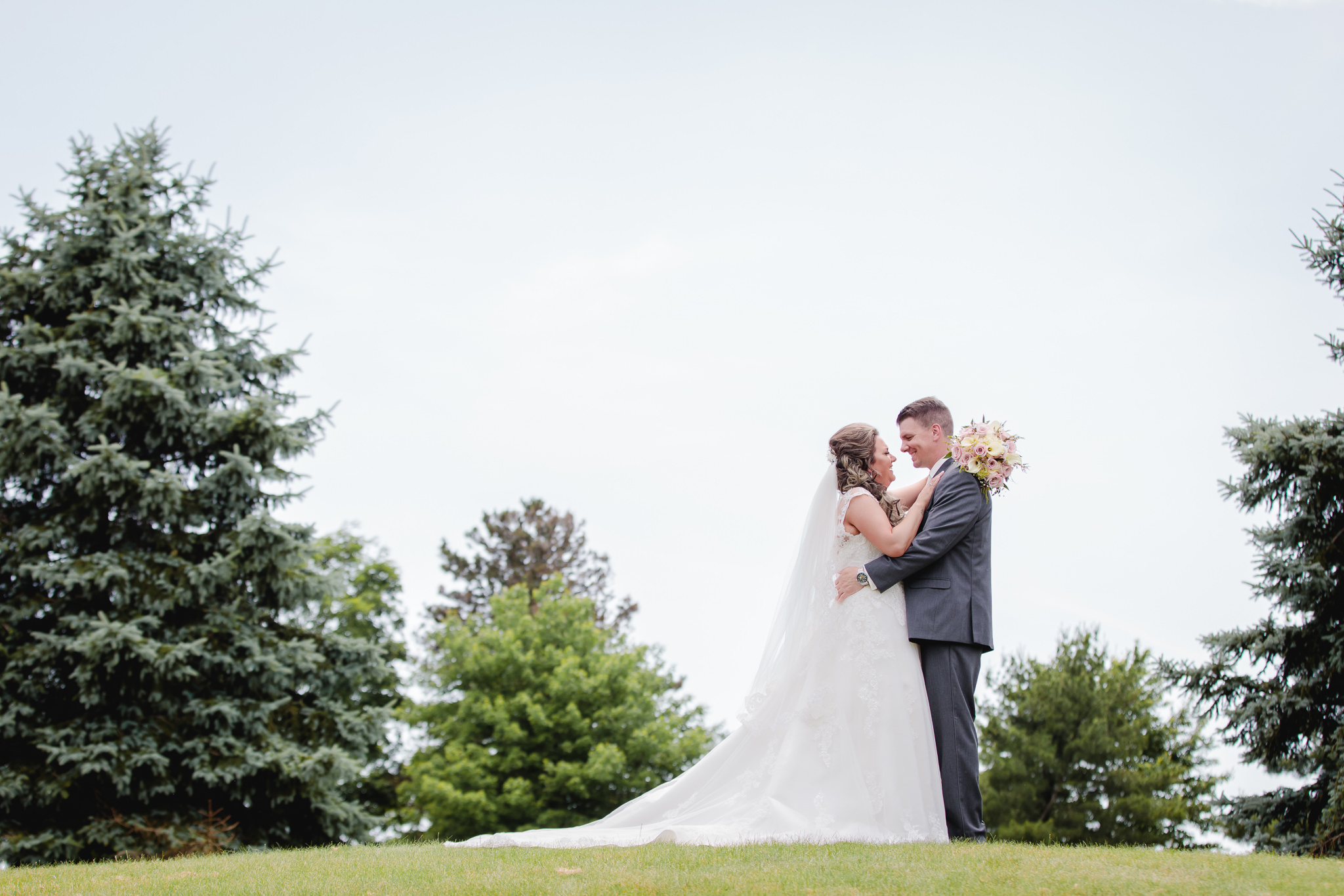 Bride and groom on a knoll at Chestnut Ridge Golf Resort