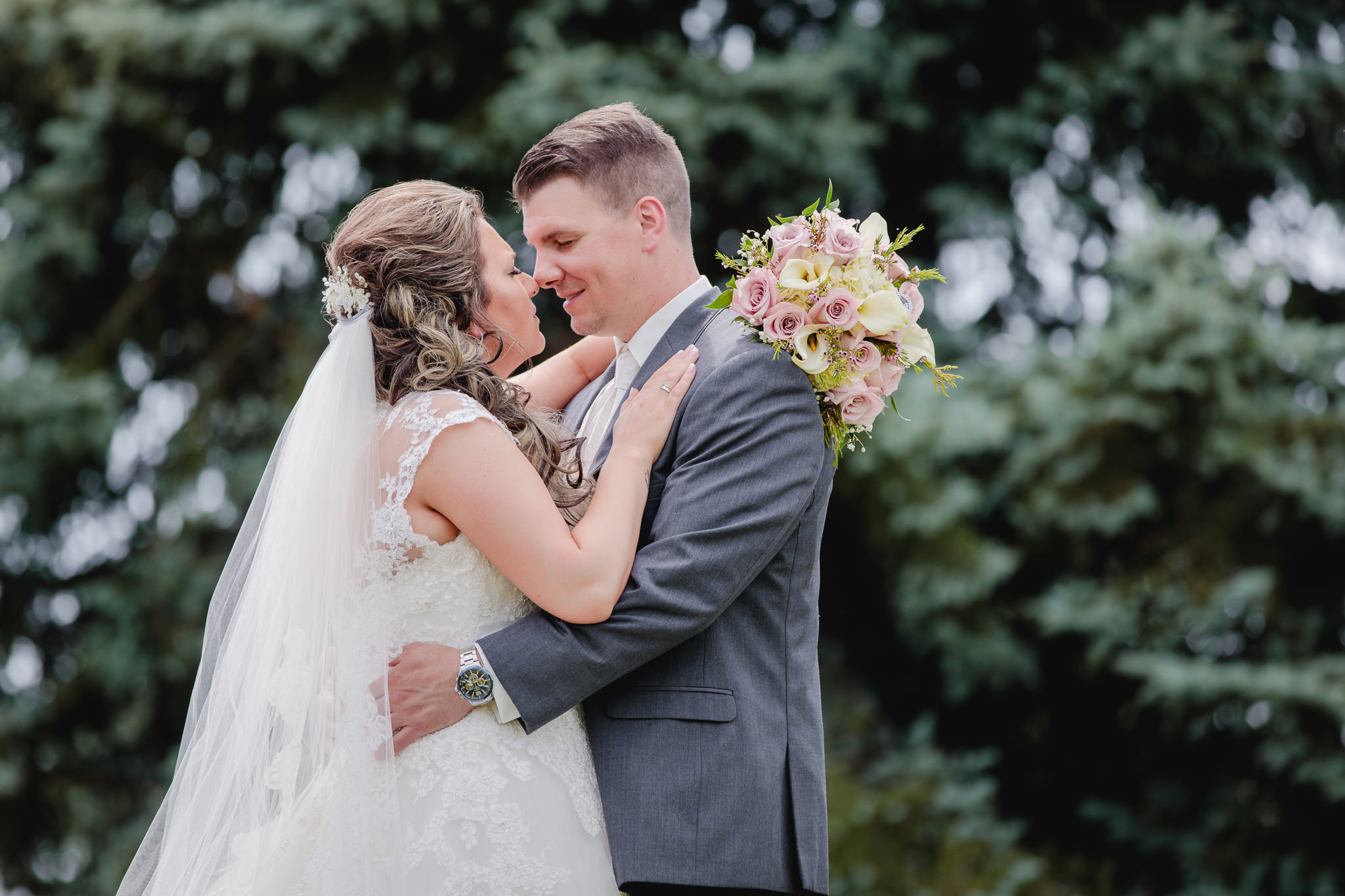 Bride and groom nuzzle noses at Chestnut Ridge Golf Resort