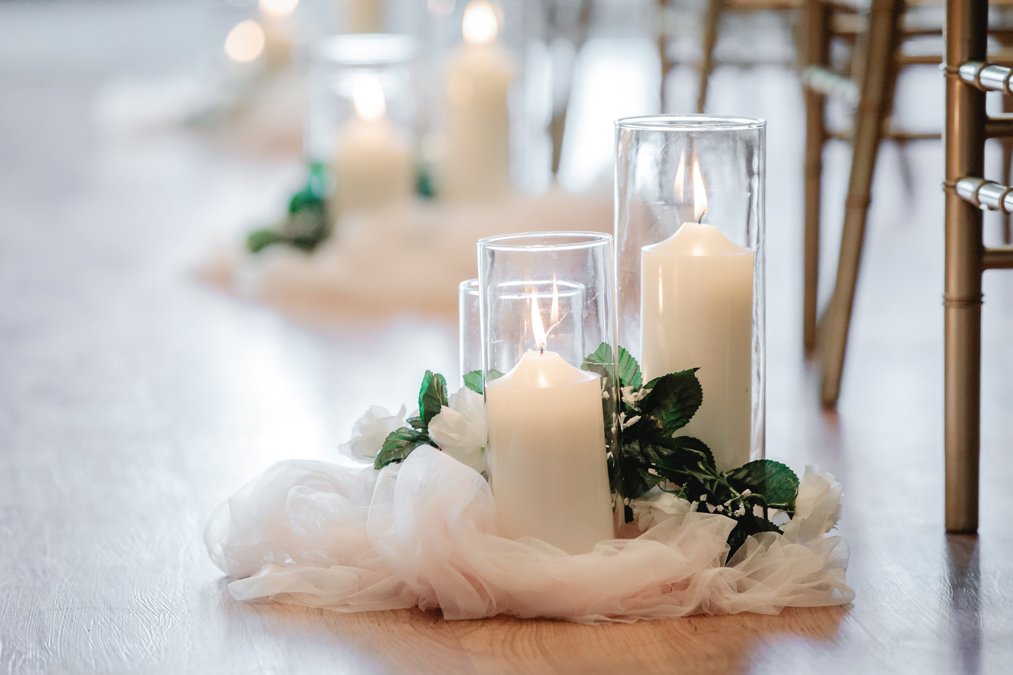 Candles line the aisle at a Chestnut Ridge Golf Resort wedding ceremony