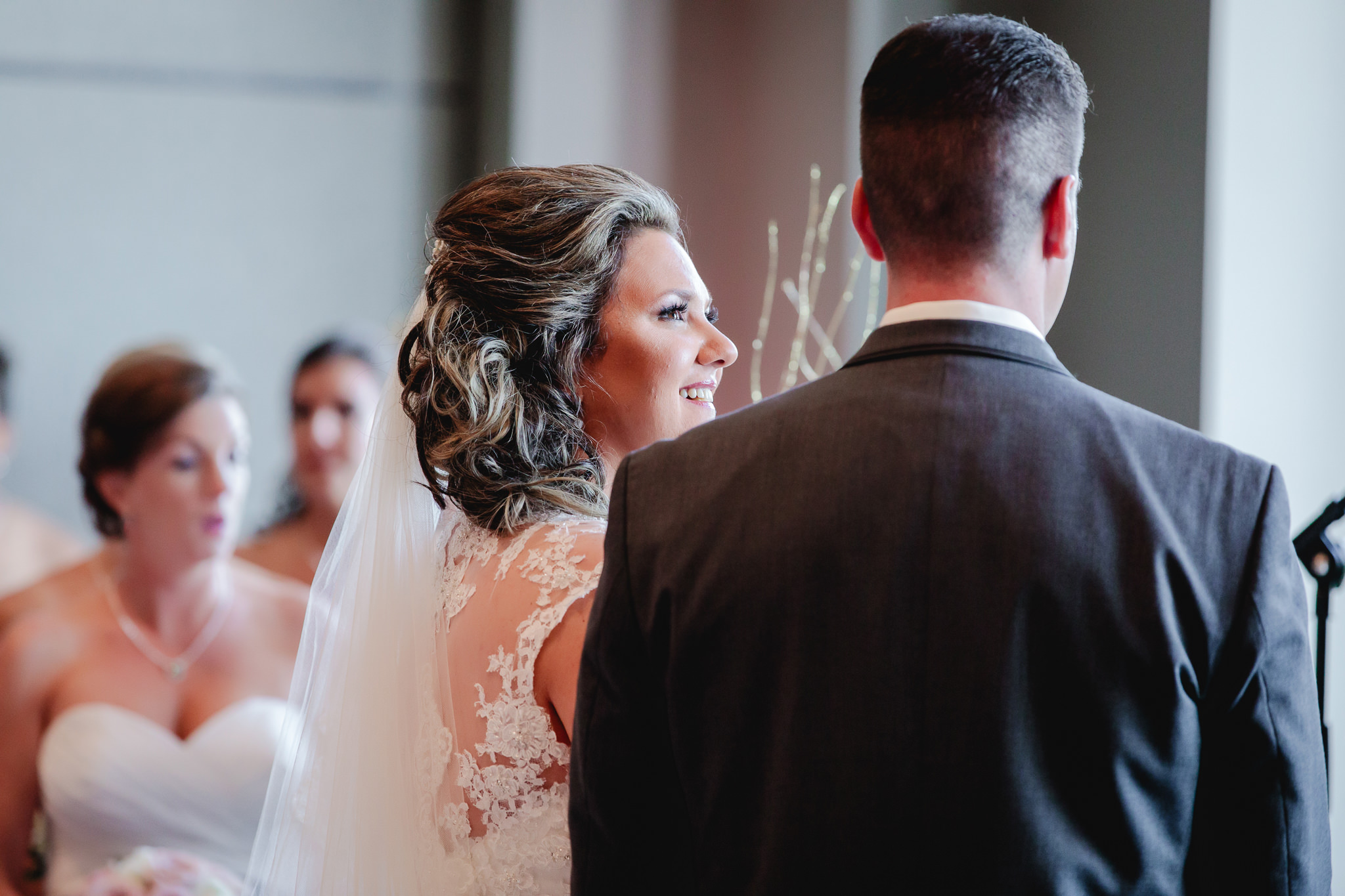 Bride smiles at her groom during their wedding ceremony at Chestnut Ridge Golf Resort