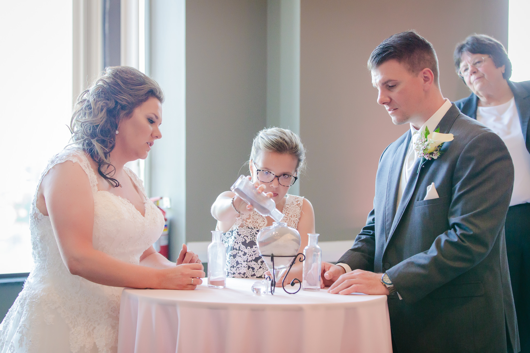 Groom's daughter pours sand during the unity ceremony at Chestnut Ridge Golf Resort