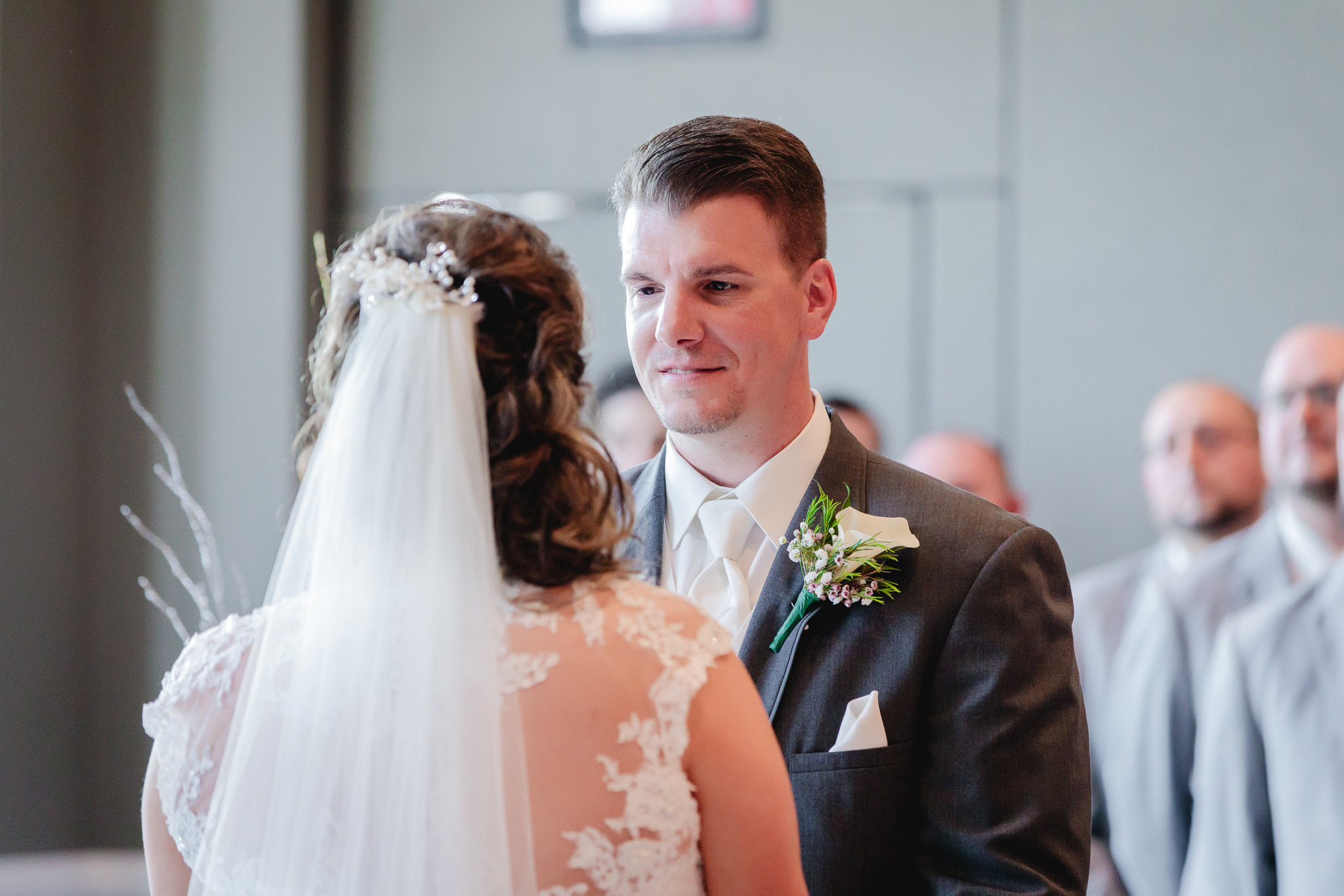 Groom smiles at his bride during their Chestnut Ridge Golf Resort ceremony