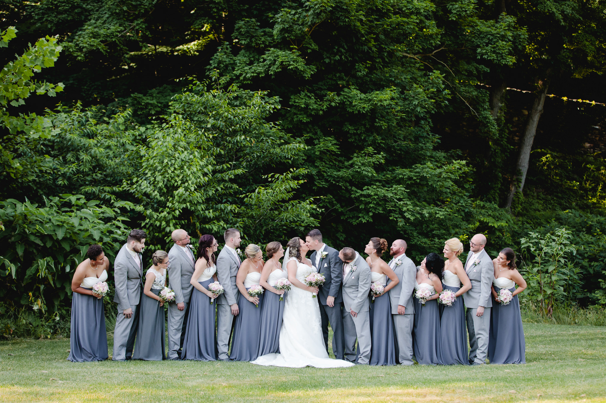 Bridal party watch as newlyweds kiss at Chestnut Ridge Golf Resort