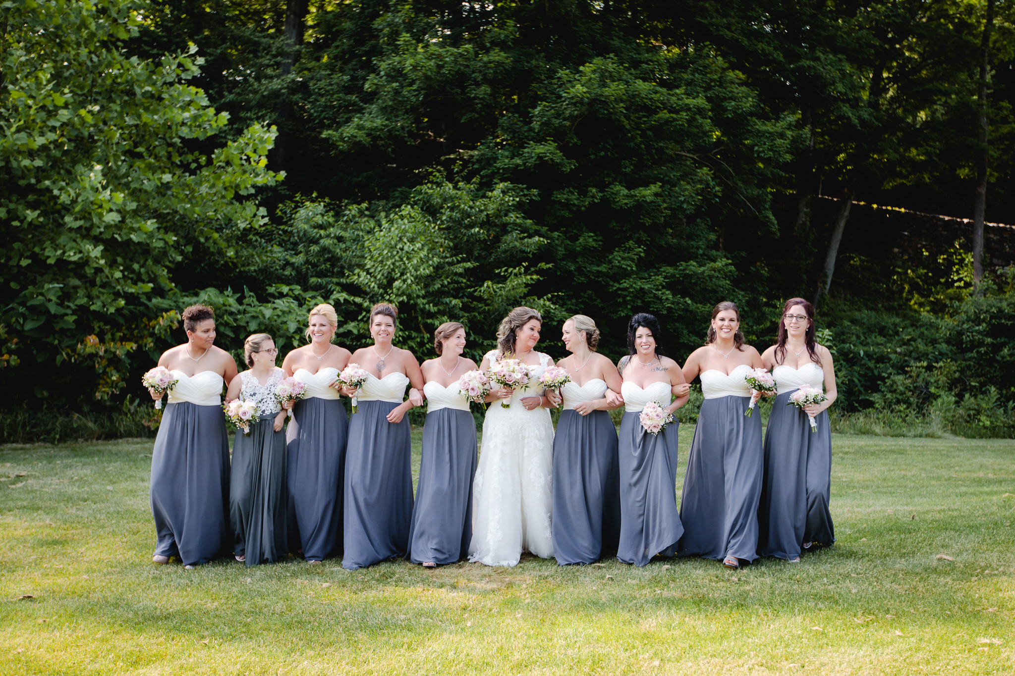 Bridesmaids laugh and walk together at Chestnut Ridge Golf Resort