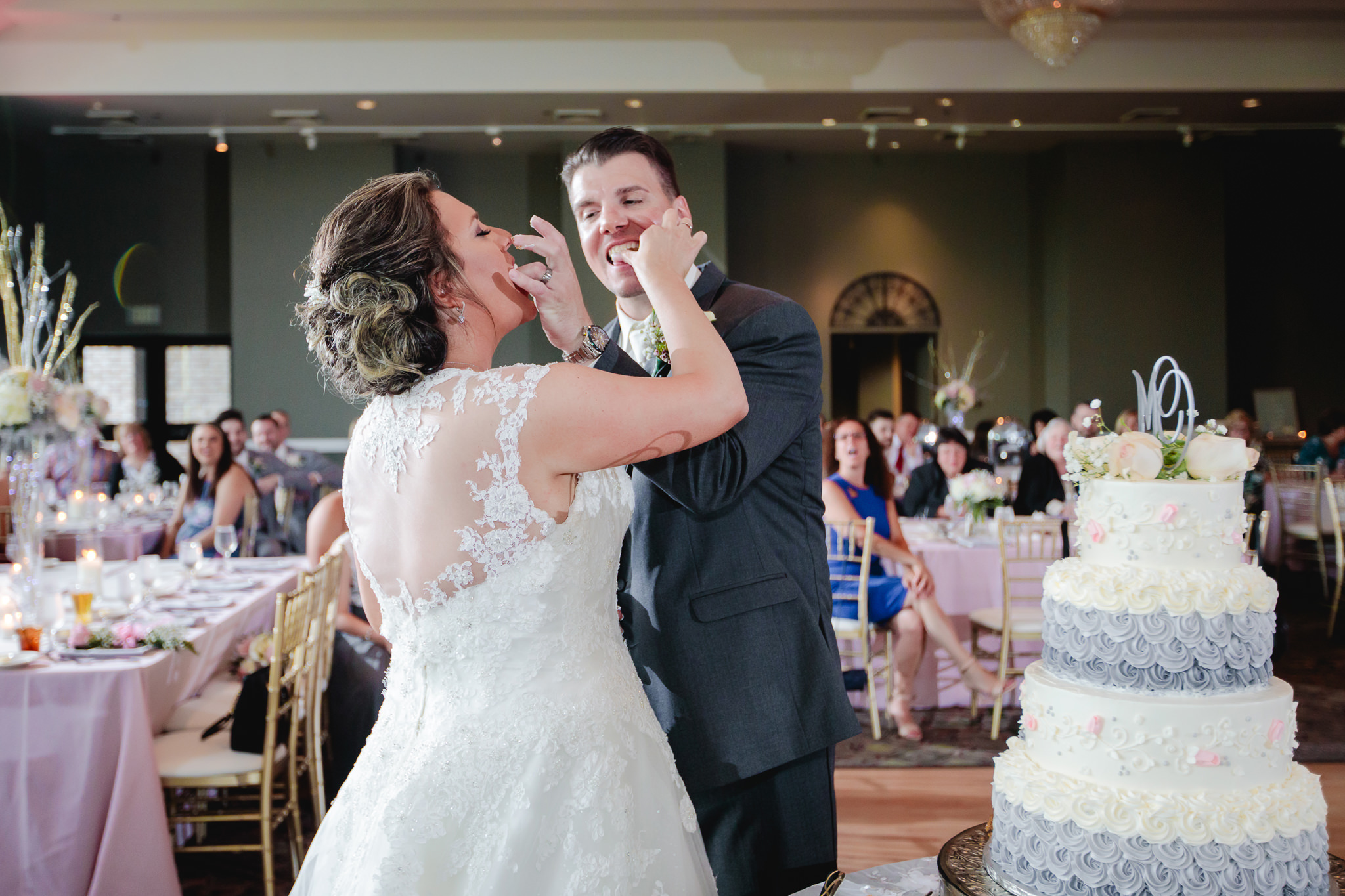 Bride and groom feed each other cake at Chestnut Ridge Golf Resort