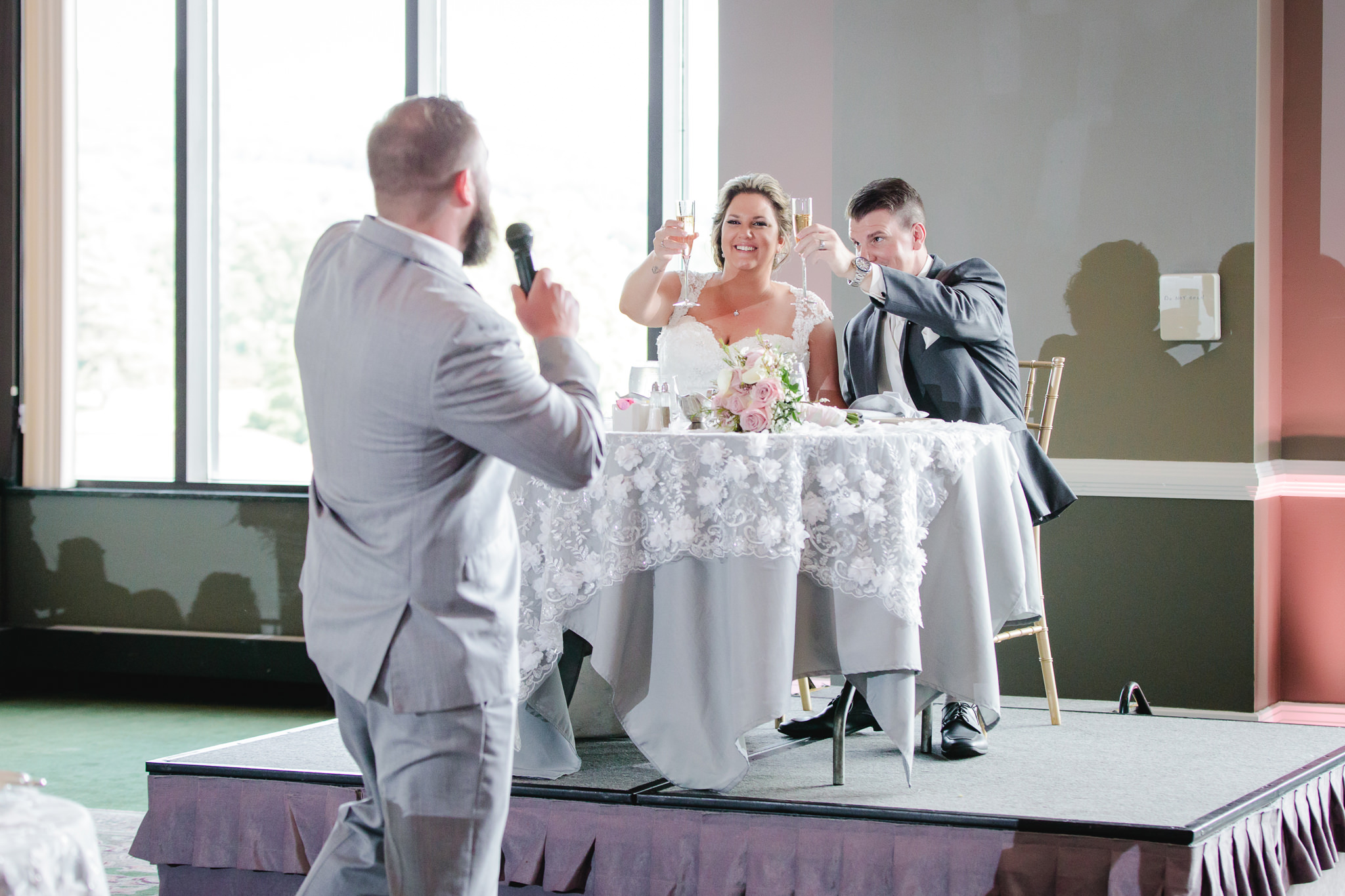 Bride and groom toast with champagne at Chestnut Ridge Golf Resort