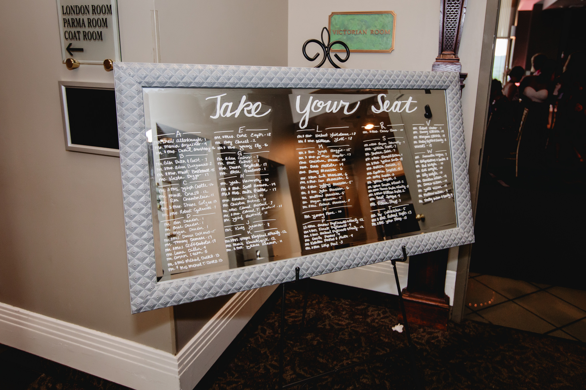 Seating chart written in calligraphy on a mirror at Chestnut Ridge Golf Resort