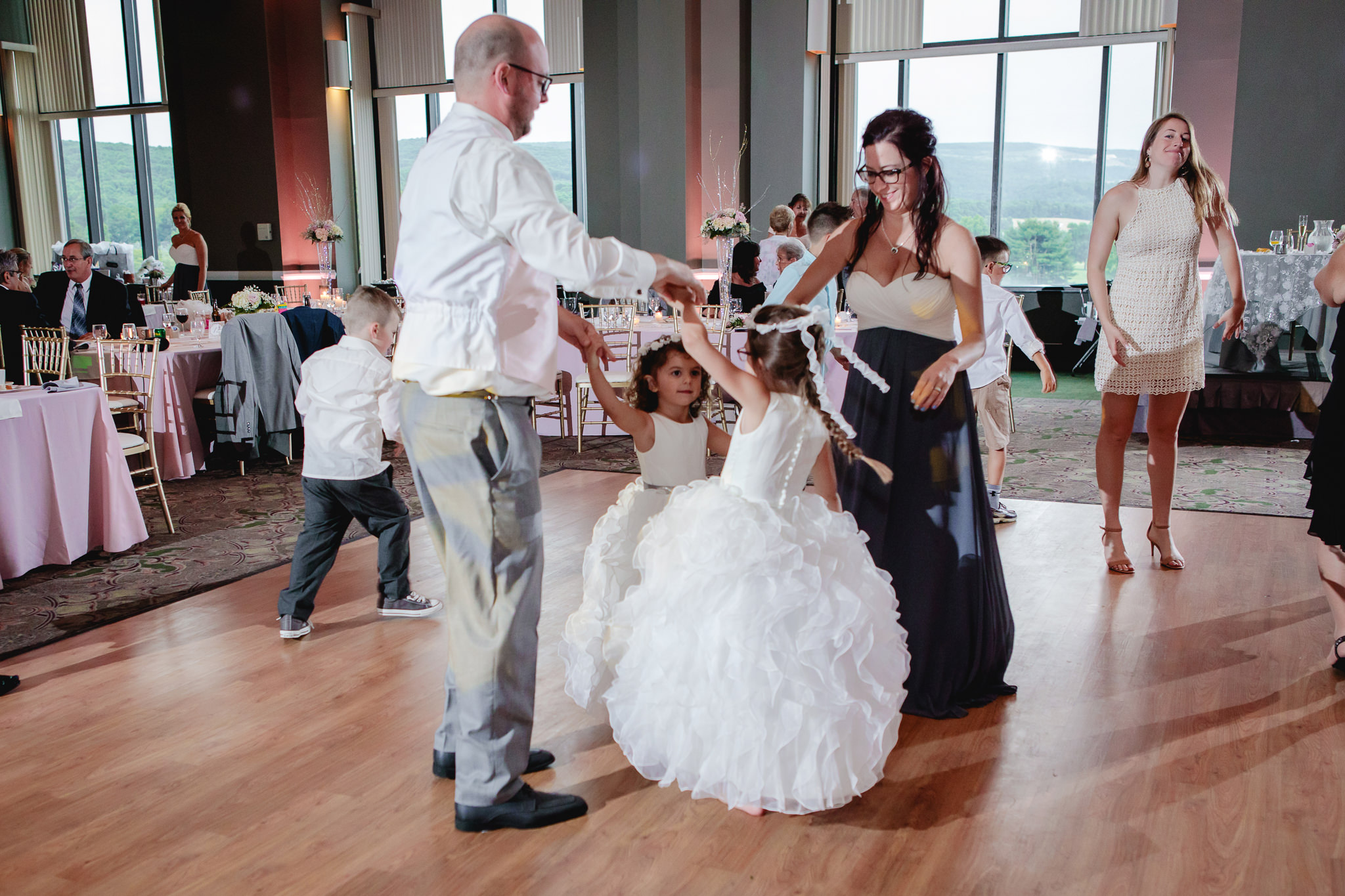 Flower girls' family dances together at a Chestnut Ridge Golf Resort wedding