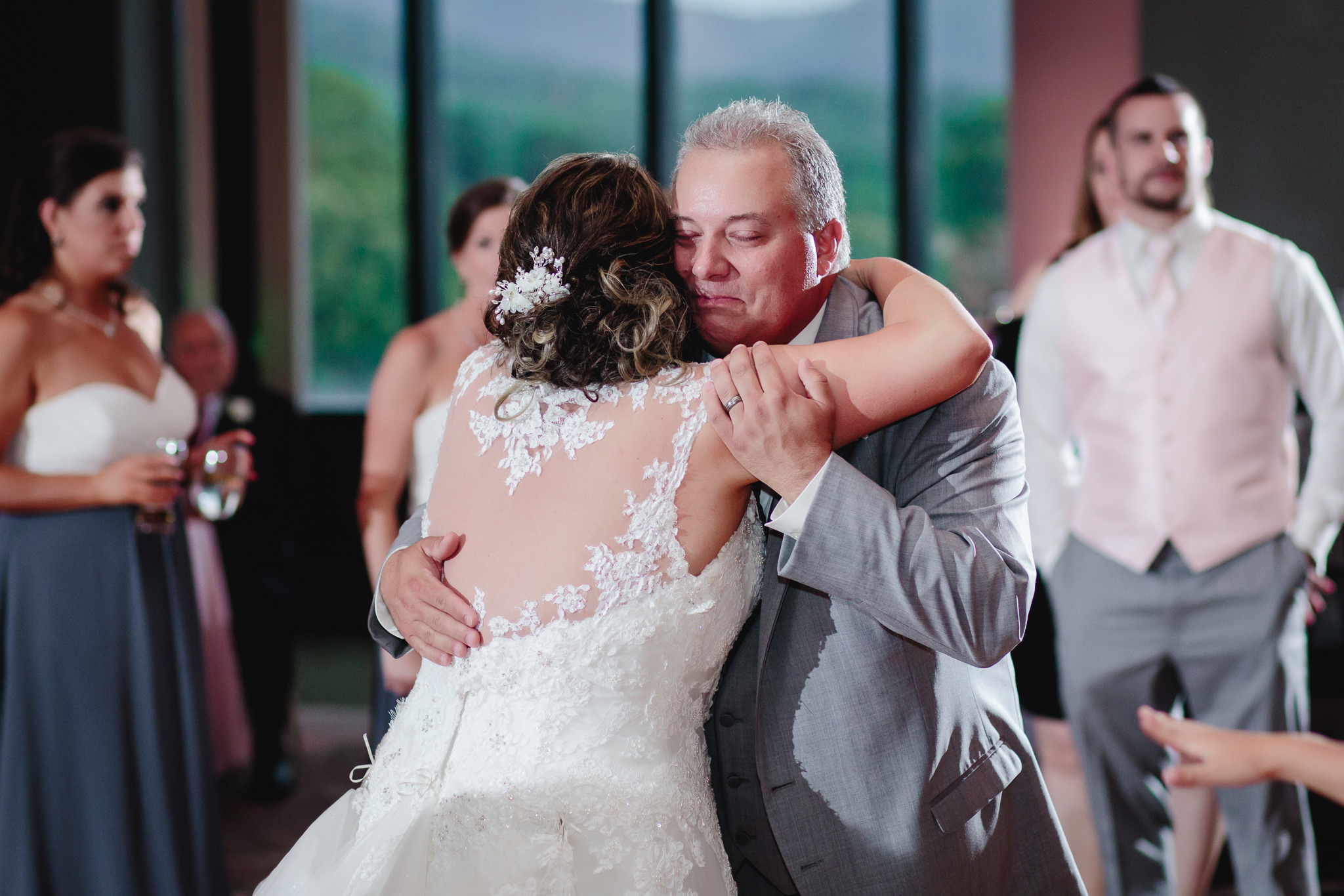 Bride's step father hugs her at Chestnut Ridge Golf Resort