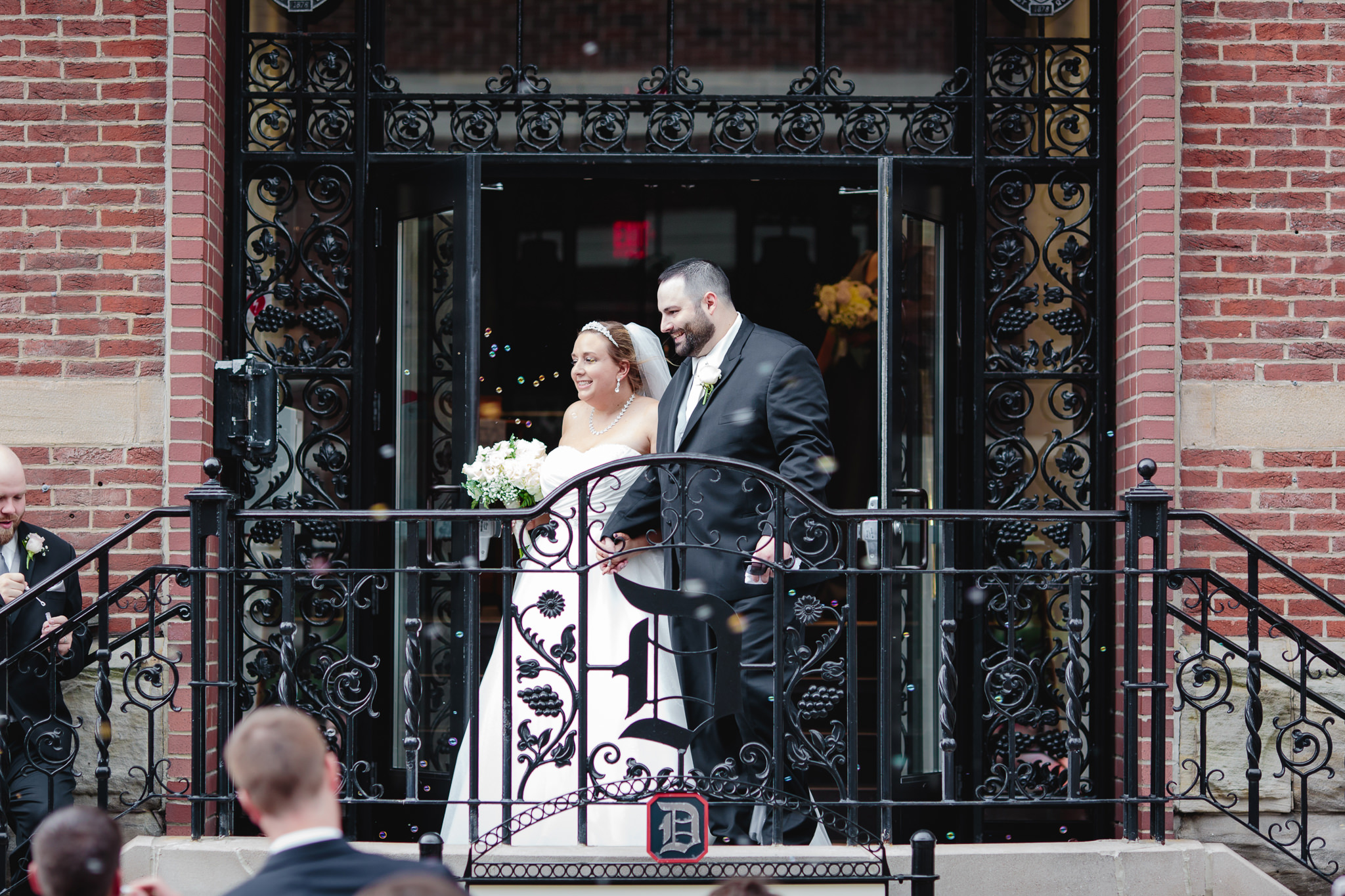 Newlyweds exit their Duquesne University wedding ceremony in a sea of bubbles