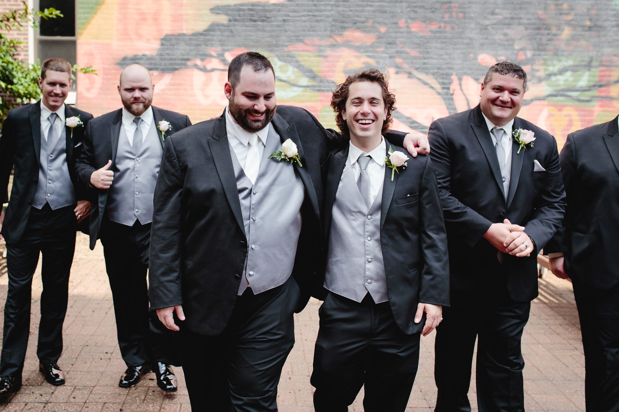Groom and best man laugh together at Duquesne University