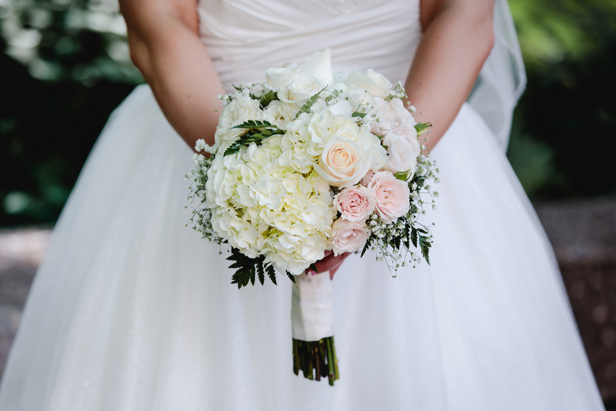 Bride holds a bouquet of flowers by Floral Magic at Duquesne University