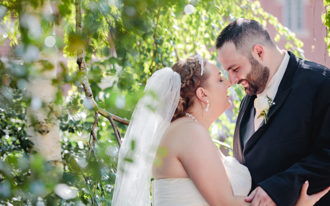 Newlyweds nuzzle noses during portraits at Duquesne University