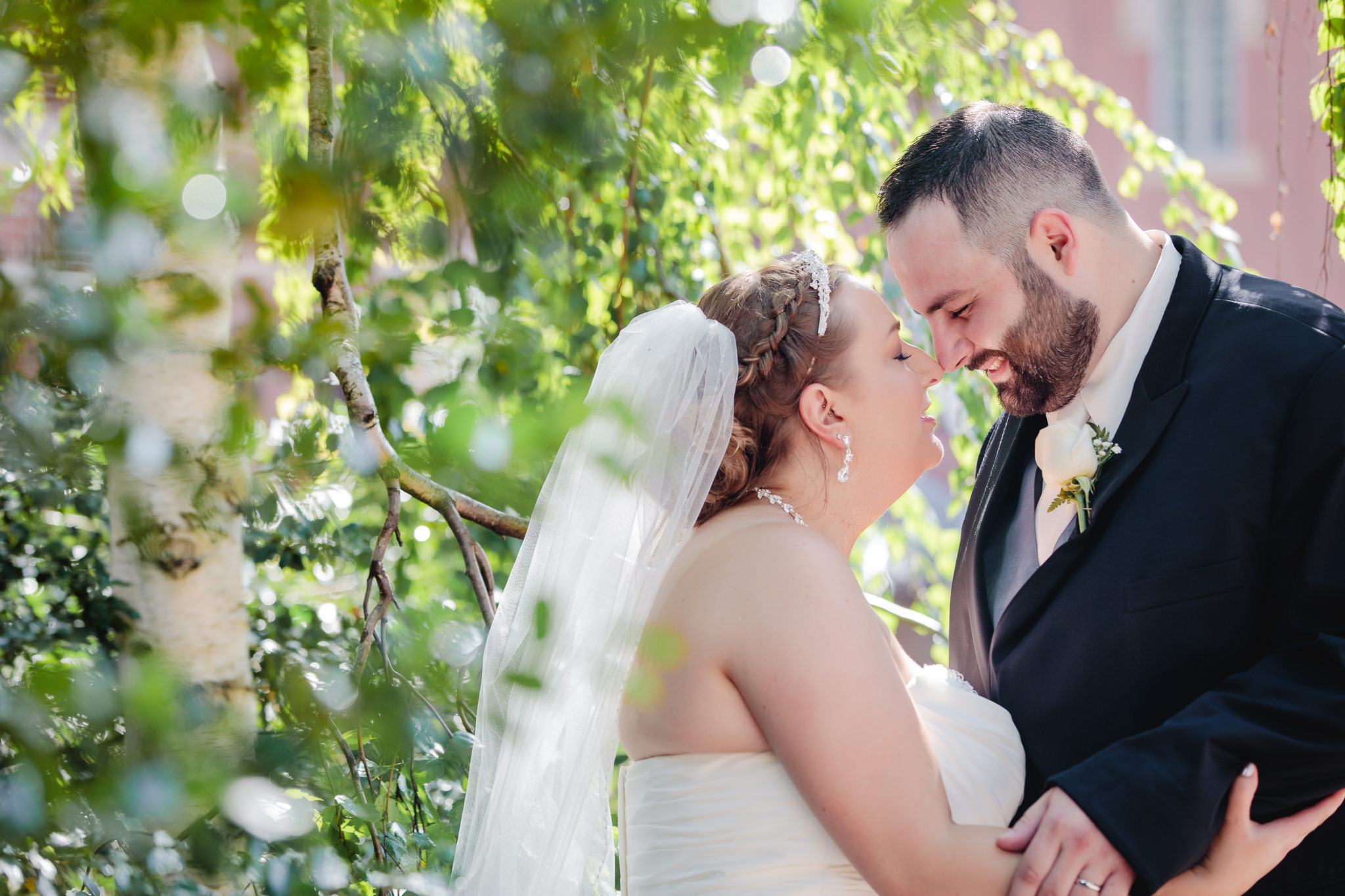 Newlyweds nuzzle noses during portraits at Duquesne University