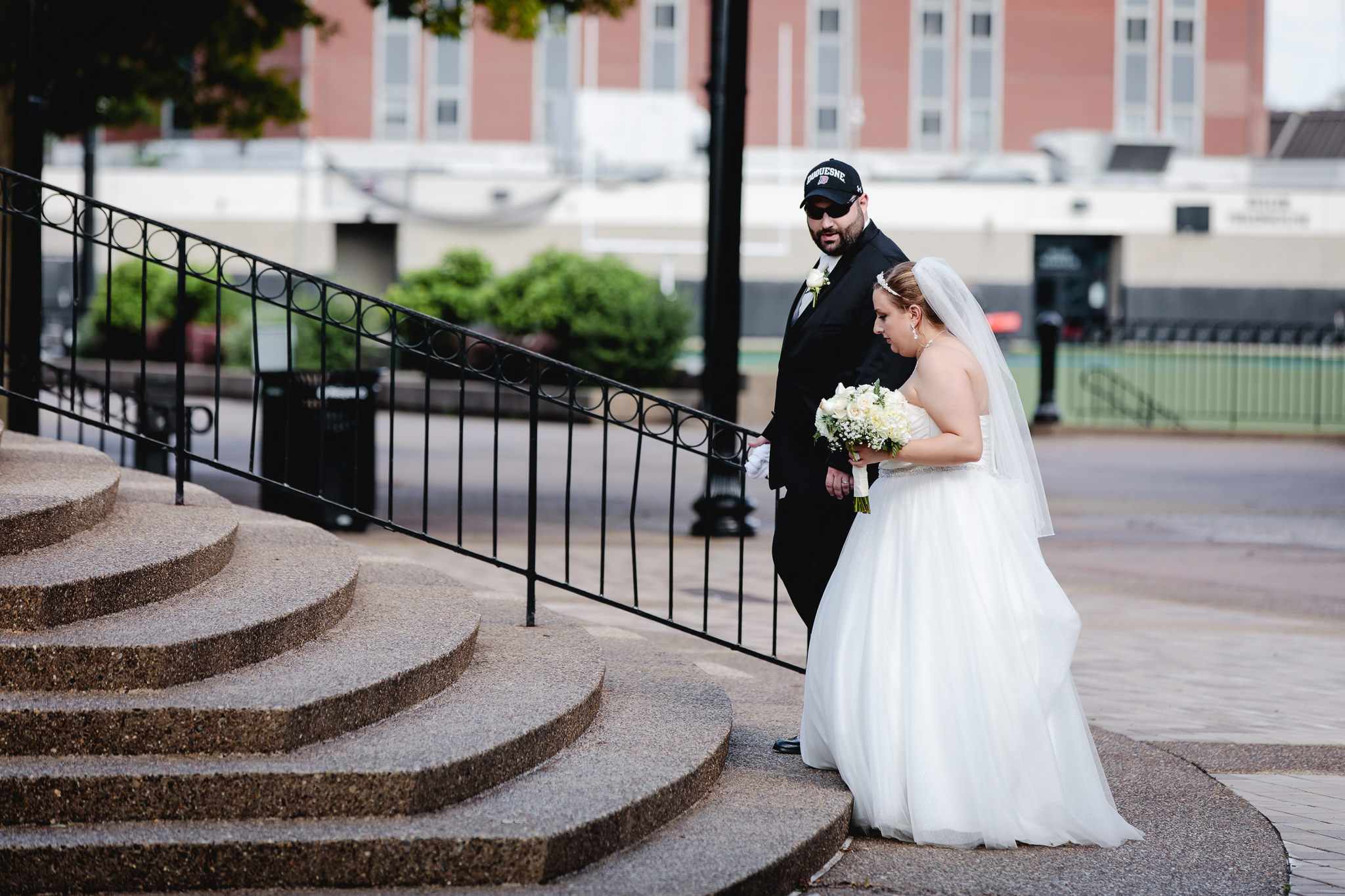 Bride & groom walk to their Duquesne University wedding reception