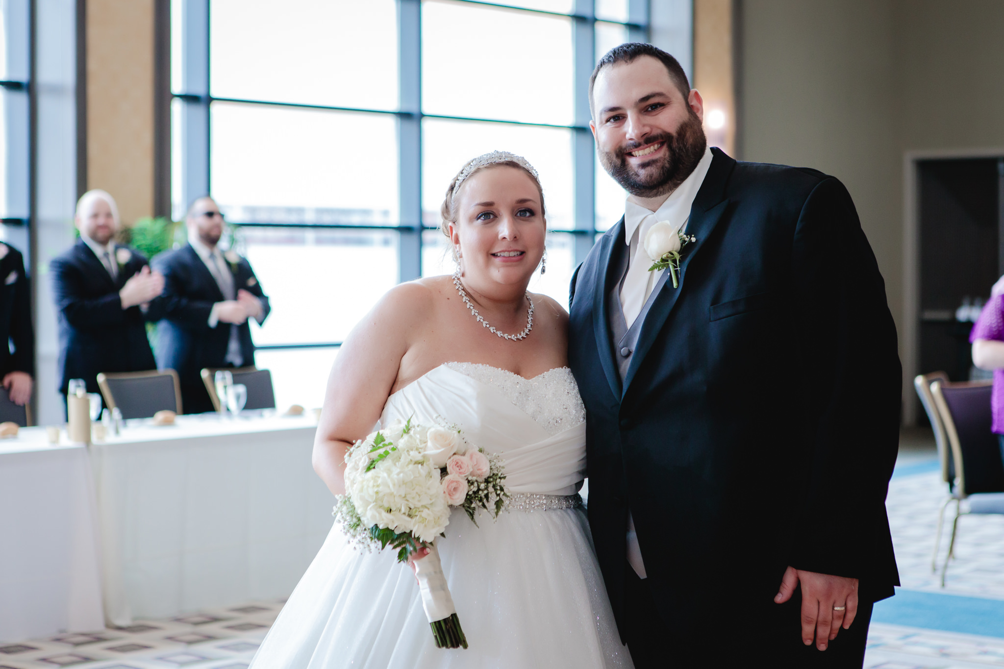 Bride & groom smile for a photo at their Duquesne University wedding reception