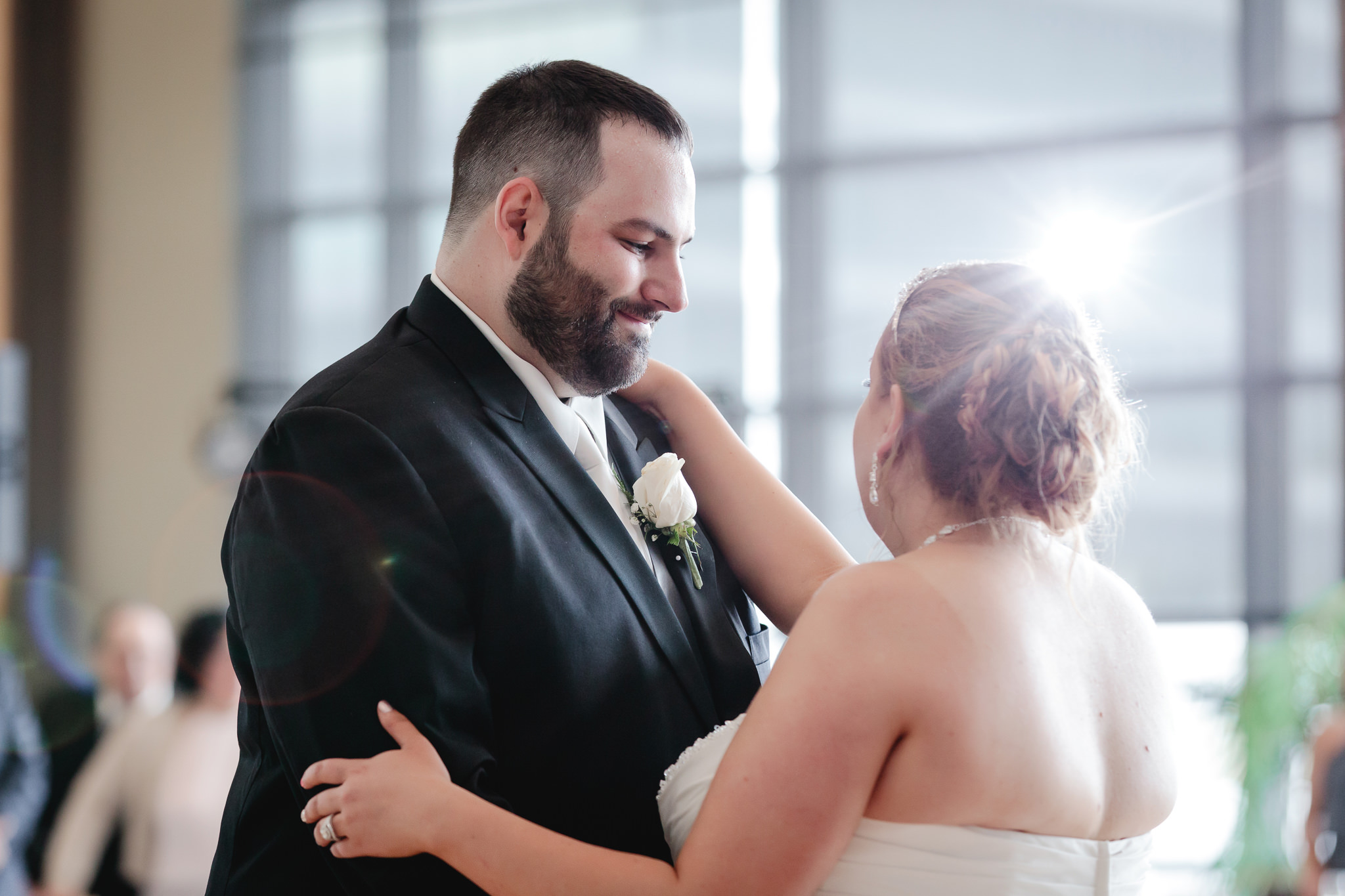 Groom smiles at his bride during their first dance at Duquesne University