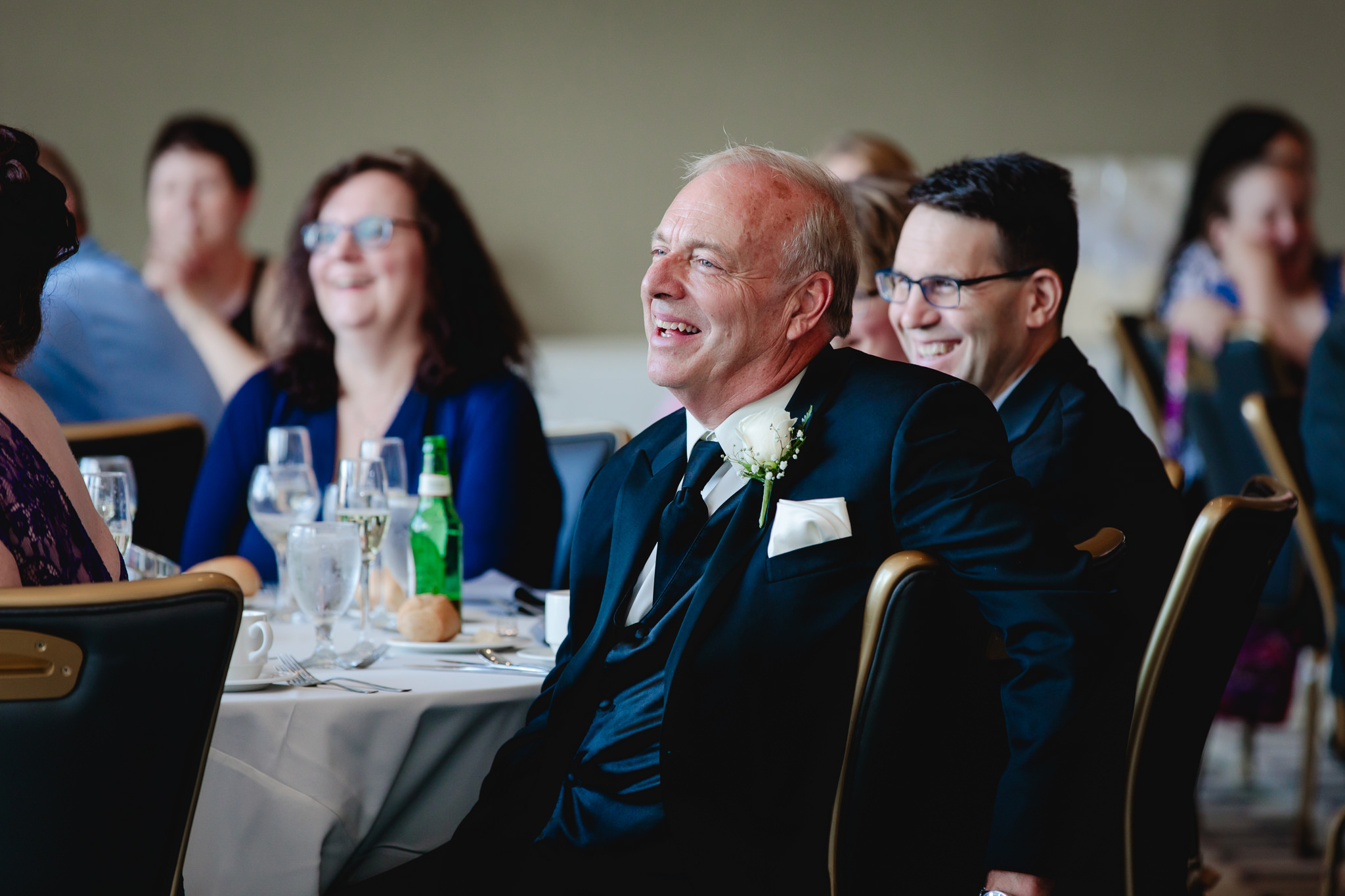 Father of the bride laughs during speeches at Duquesne University