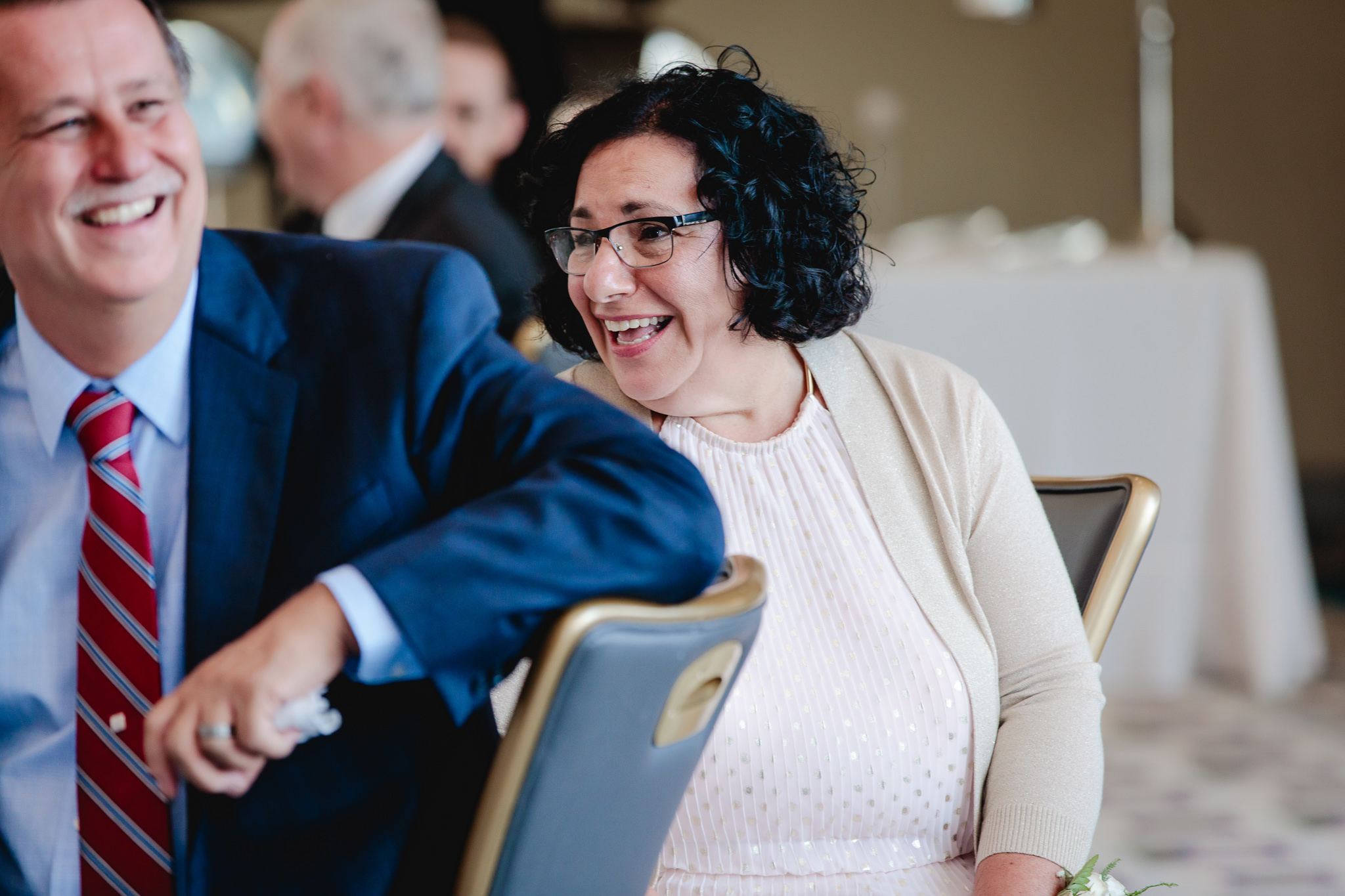 Mother of the groom laughs during speeches at a Duquesne University wedding
