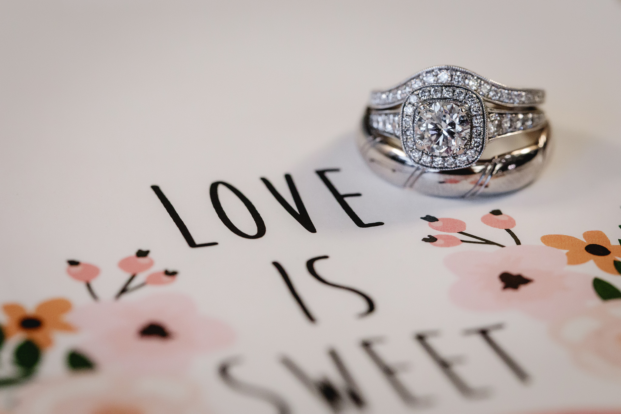 Diamond engagement ring and wedding bands by the word Love