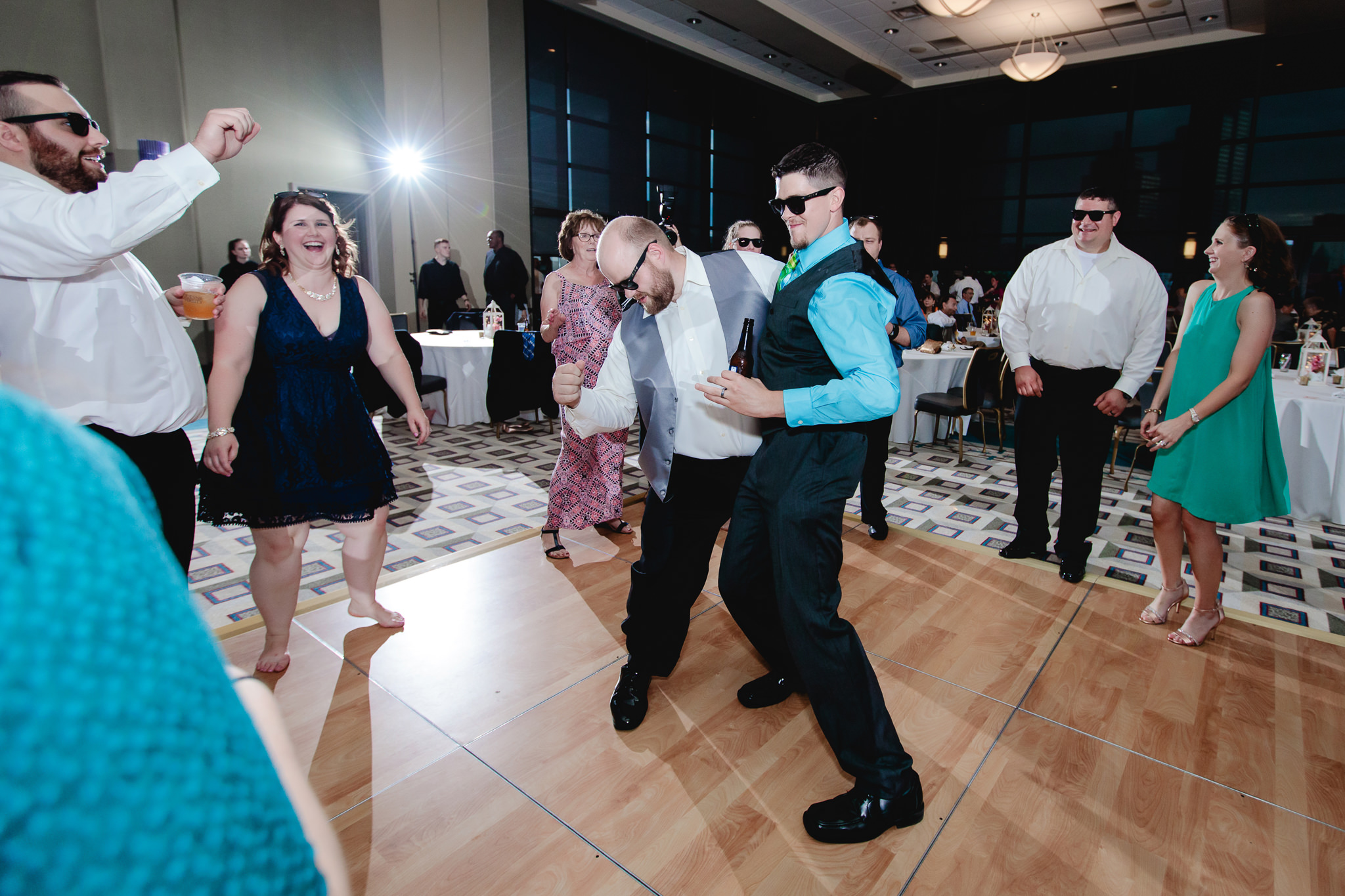 Groomsman dances with a guest at Duquesne University