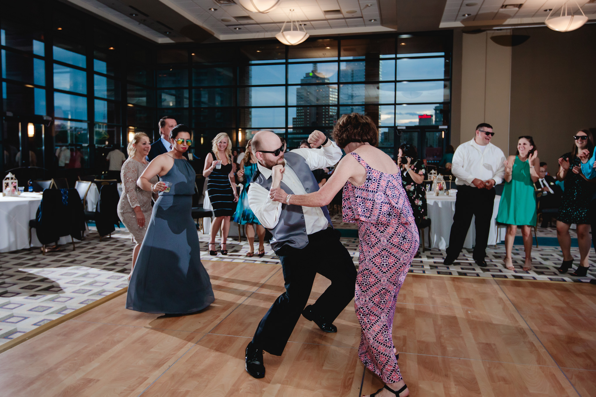Groomsman dances with a guest at a Duquesne University wedding