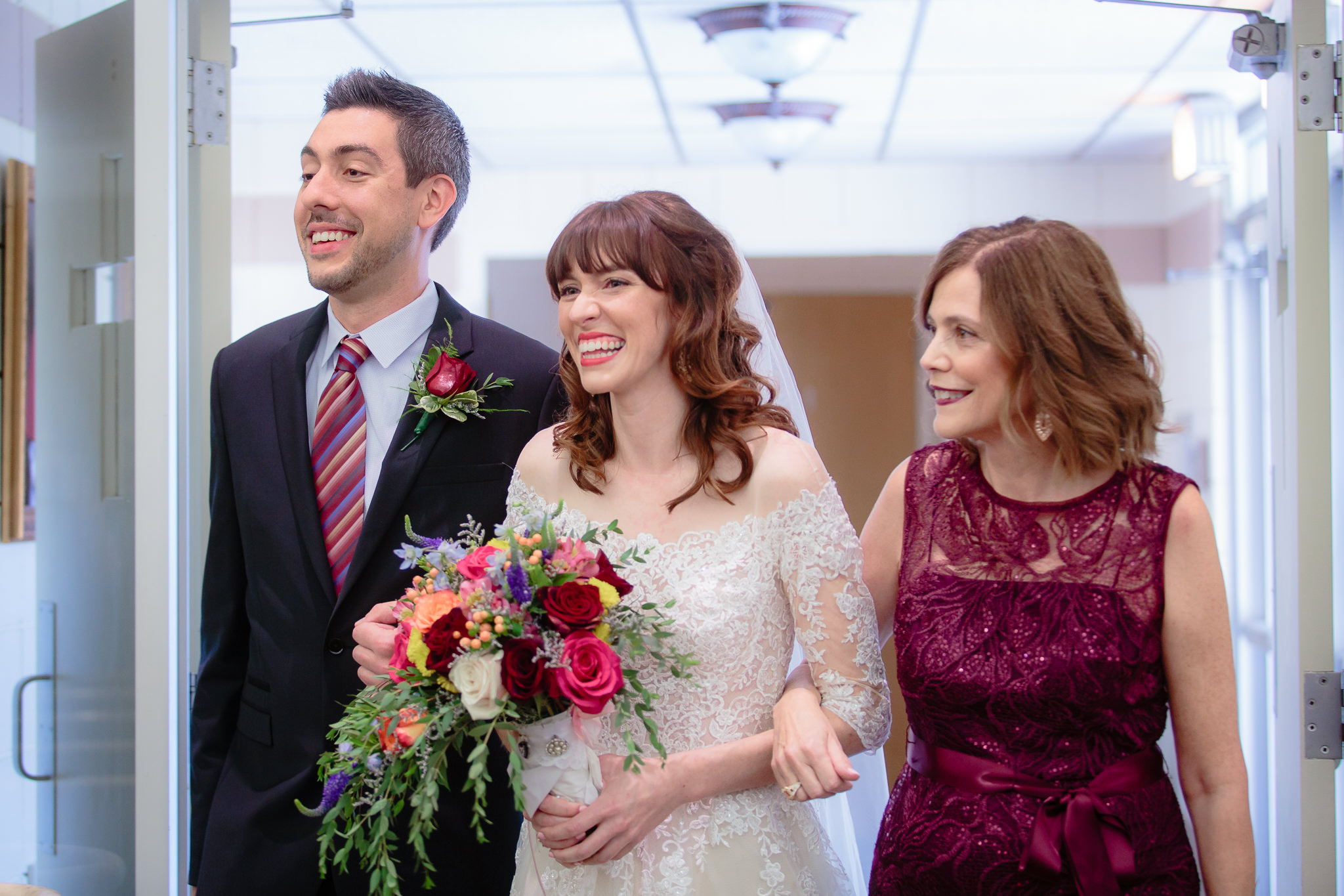 Mother and brother of the bride escort her into her ceremony at Saint Monica Parish