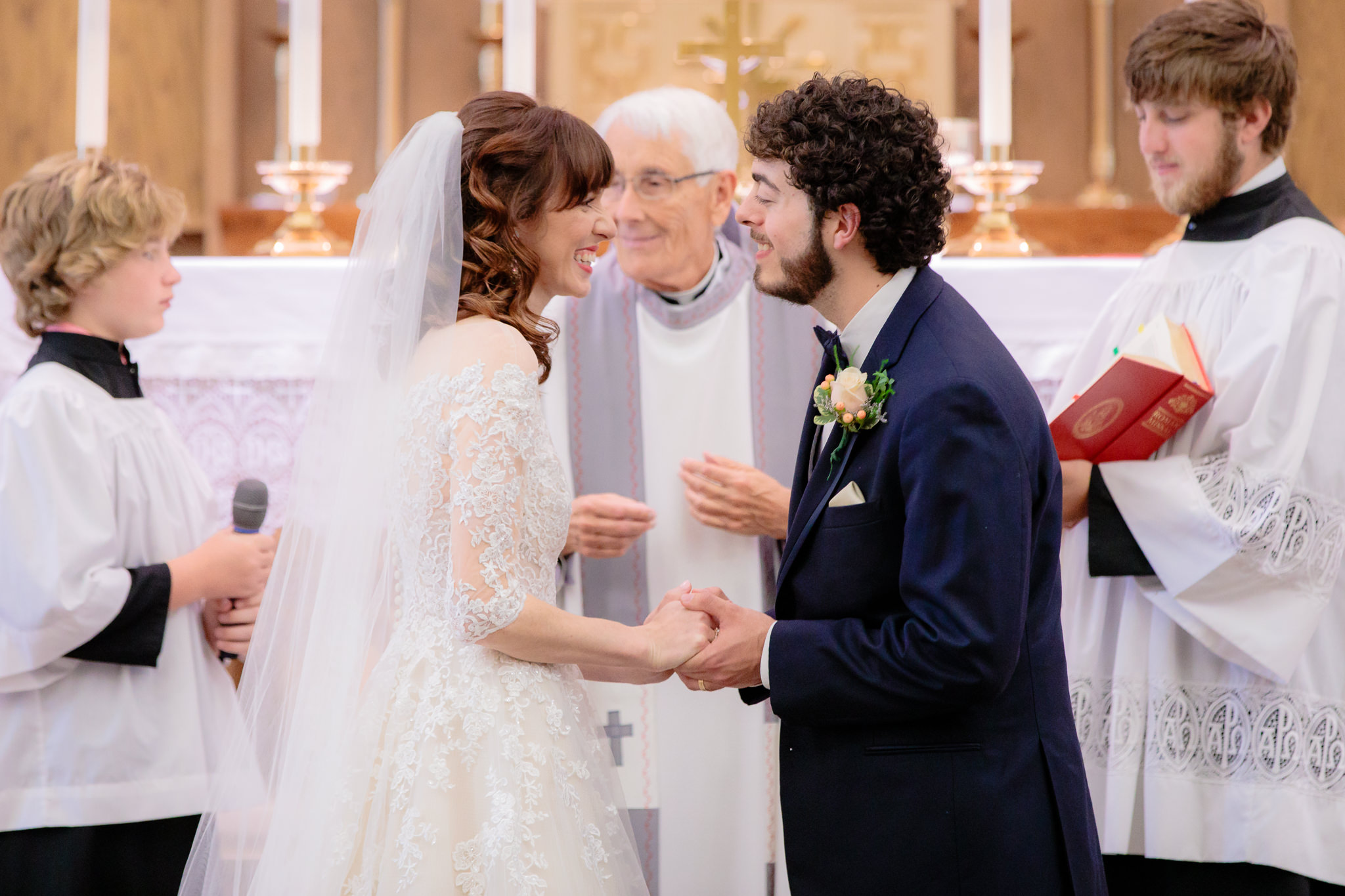 Bride & groom smile at each other after saying their vows at Saint Monica Parish