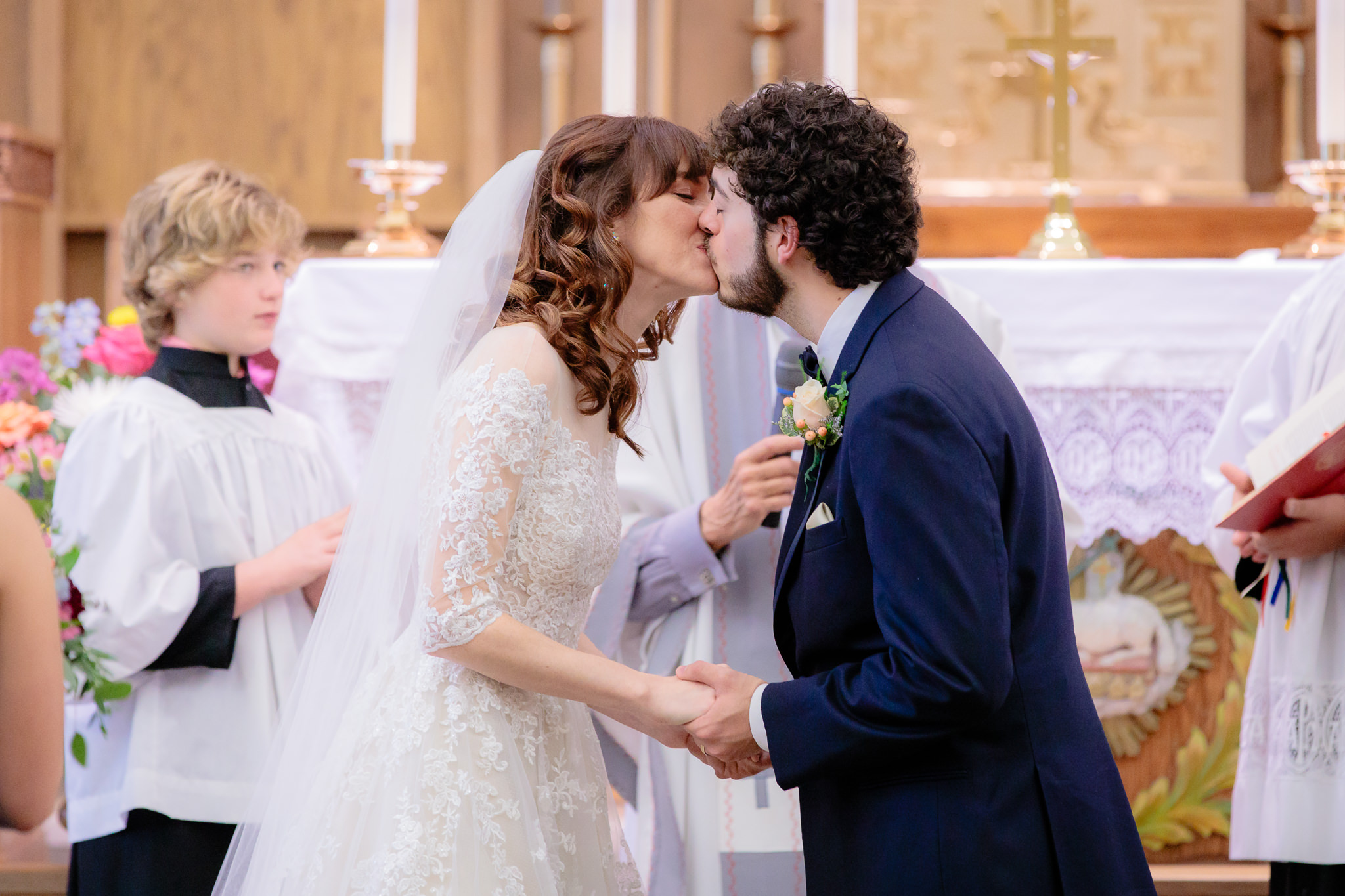 Bride & groom share their first kiss at Saint Monica Parish