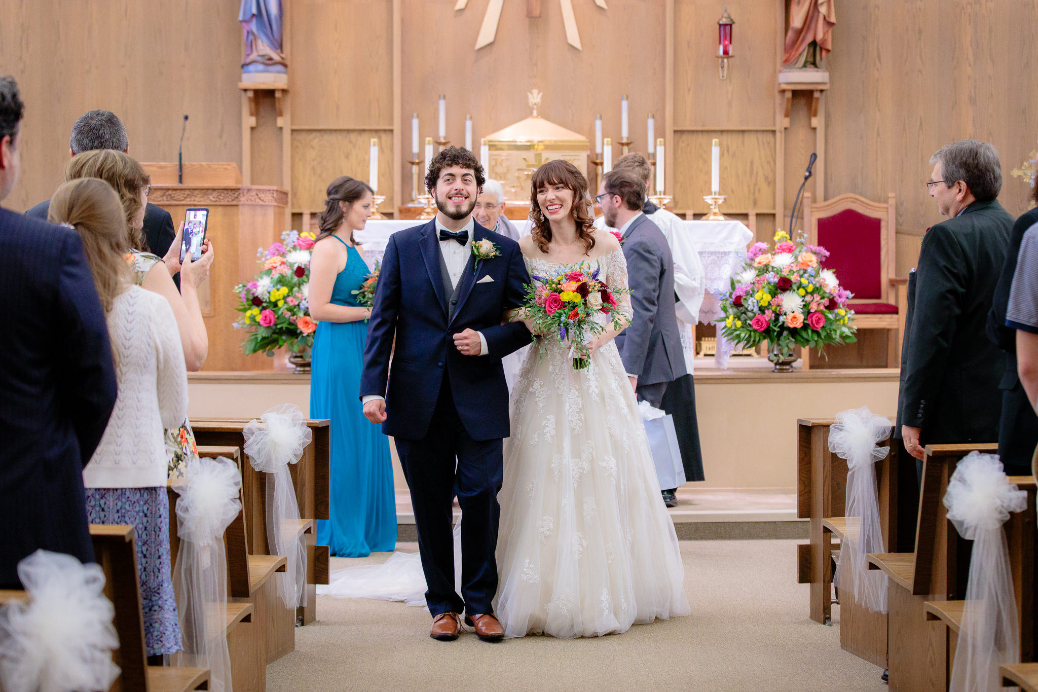 Newlyweds exit their wedding ceremony at Saint Monica Parish