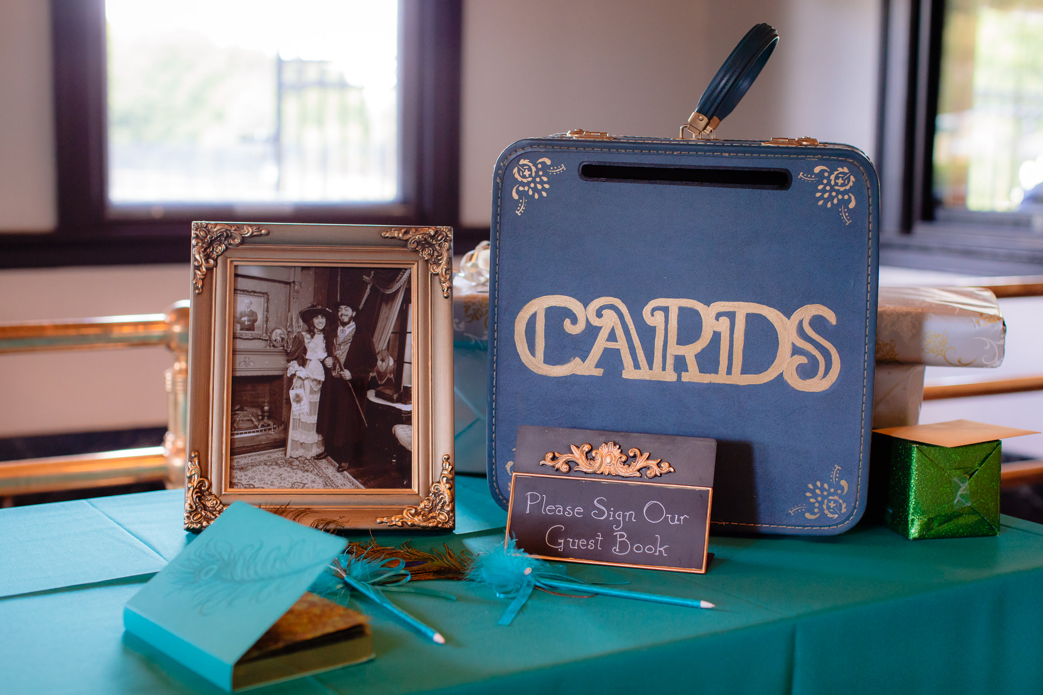 Vintage suitcase card box with feather pen guest book at a Beaver Station wedding