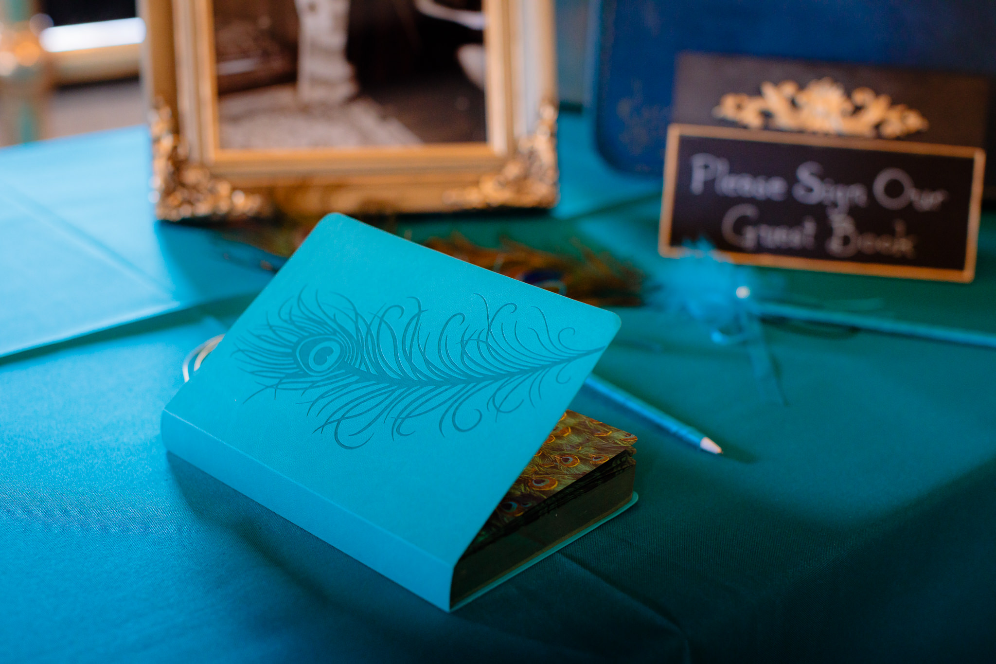 Turquoise peacock feather guest book at a Beaver Station wedding