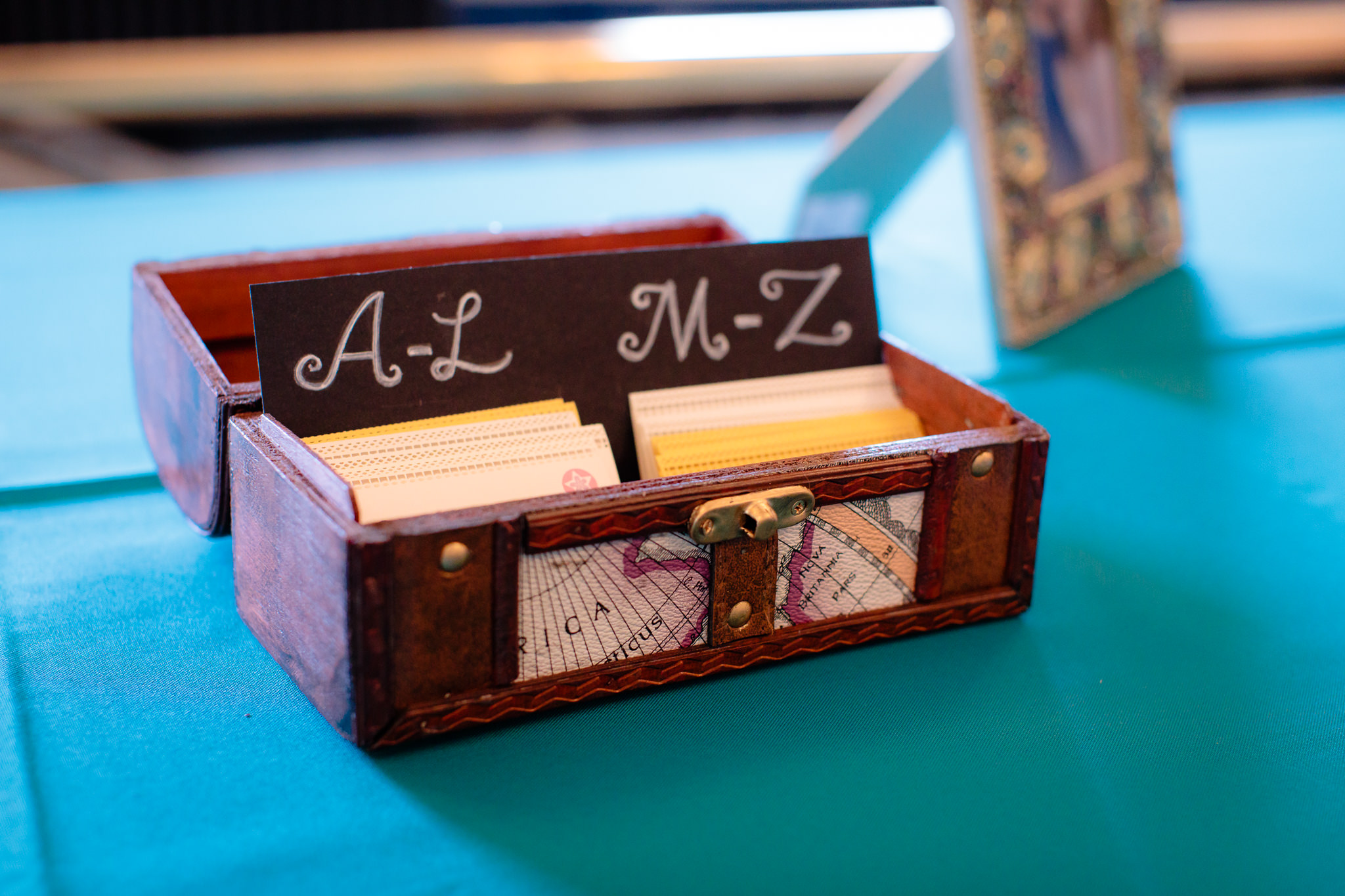 Vintage box holds escort cards at a Beaver Station wedding reception