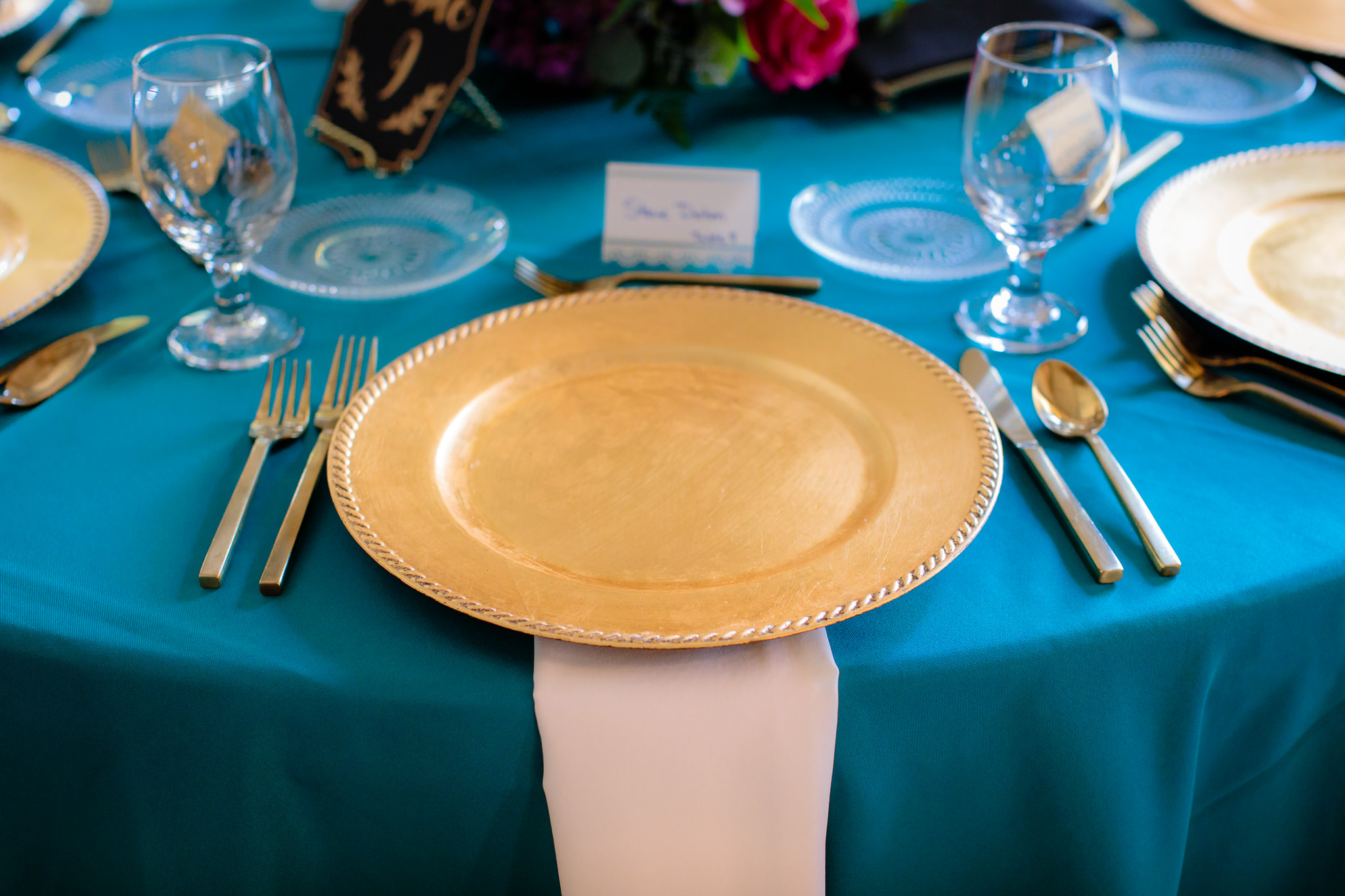 Gold charger plates from JPC Event Group at a Beaver Station wedding reception