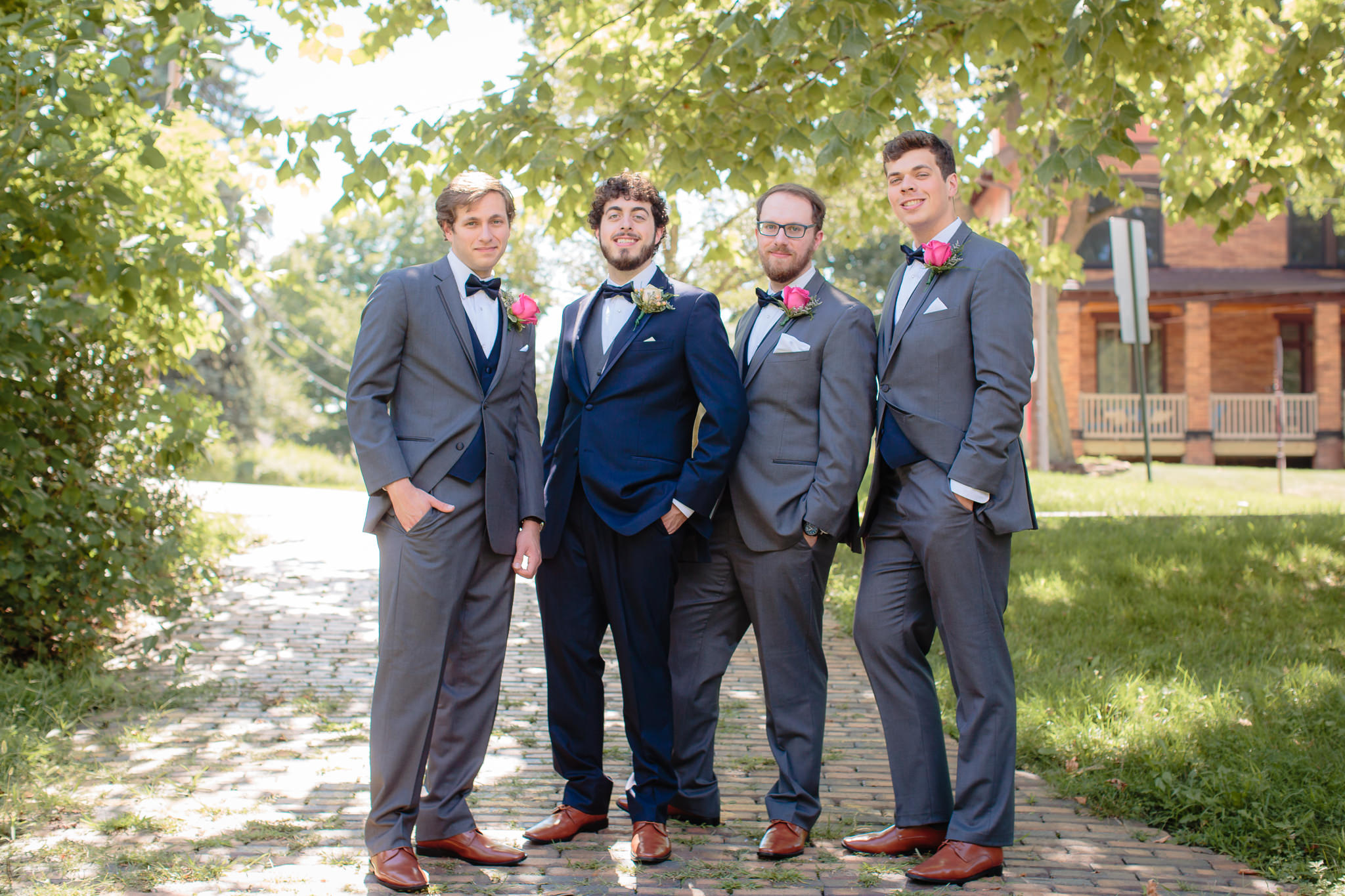 Groomsmen pose in an alley near Beaver Station