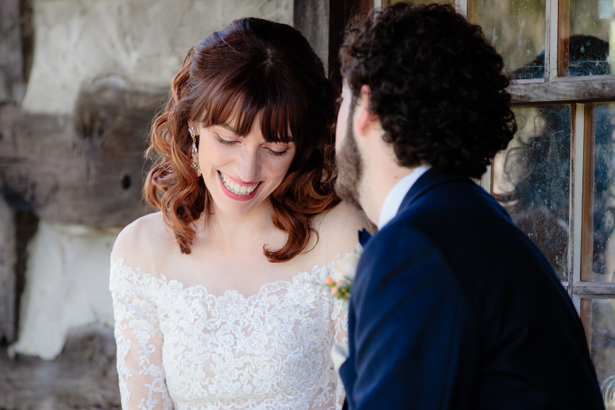 Newlyweds share a quiet moment at a log cabin at Beaver Station Cultural & Event Center