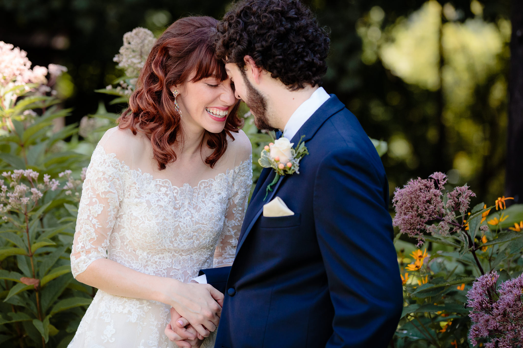 Newlyweds laugh in the flowers at Beaver Station