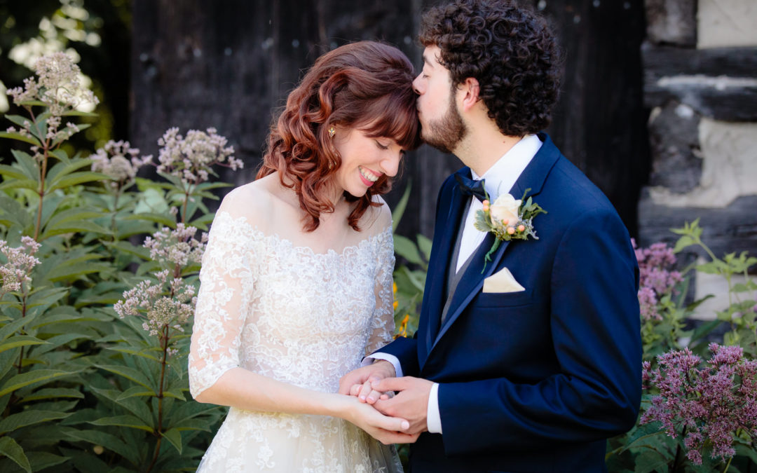 Groom kisses the bride's forehead during portraits at Beaver Station