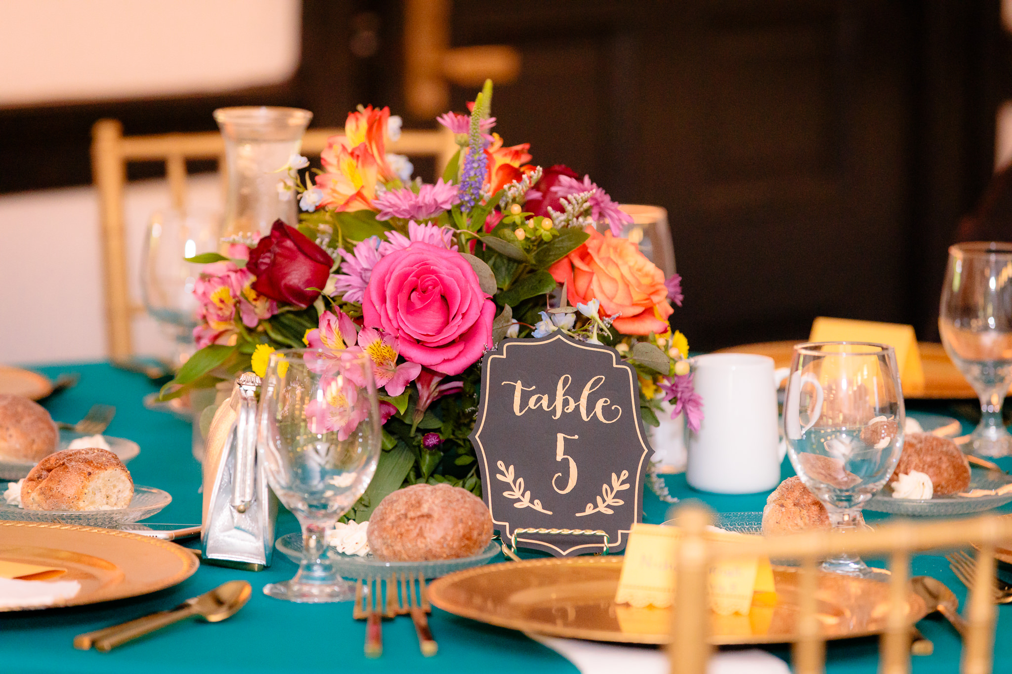 Colorful floral centerpieces by Patti's Petals Flower Shop at a Beaver Station wedding reception