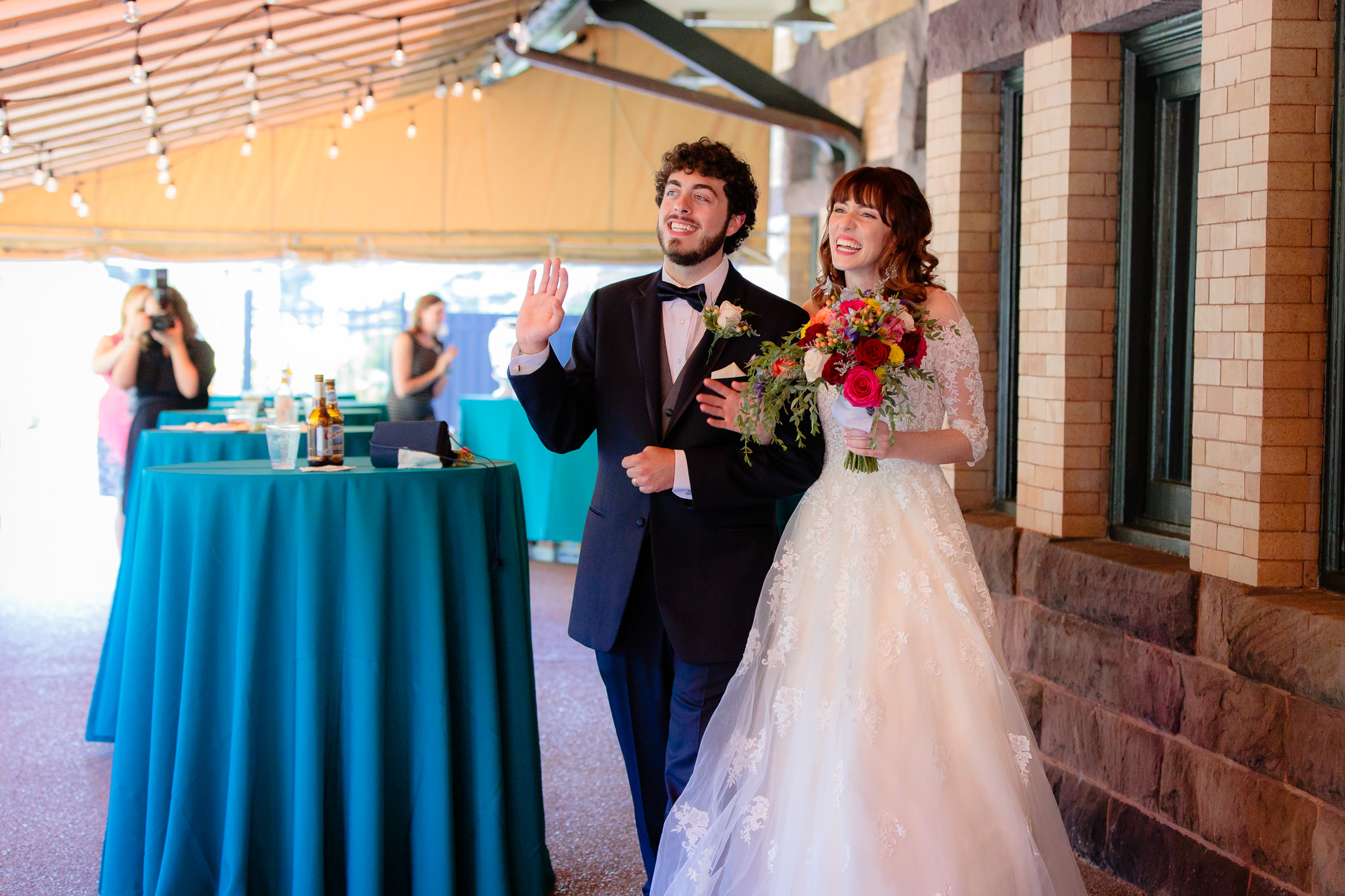 Newlyweds enter their wedding reception on the porch at Beaver Station